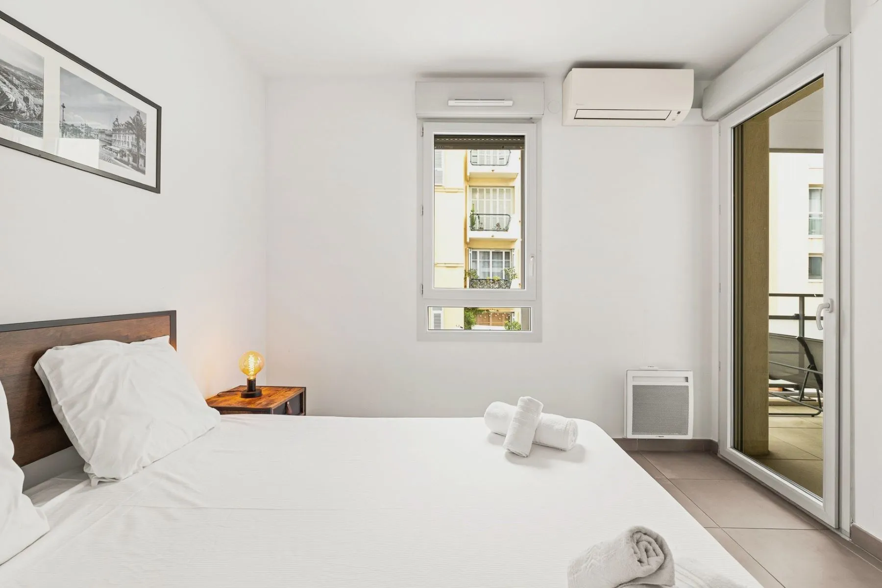 Air-conditioned double bedroom with glazed doors opening toward the private terrace
