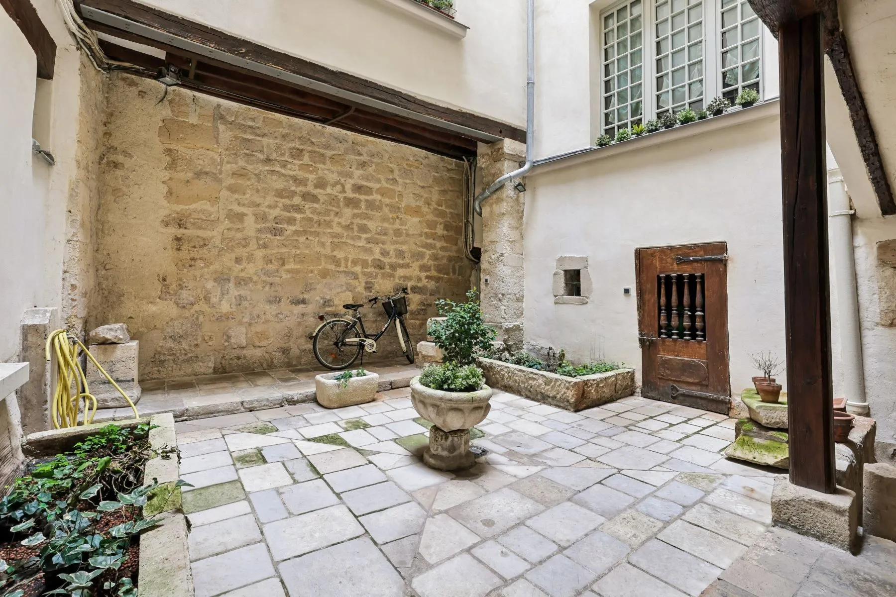 Protected stone courtyard within the historic Latin Quarter building