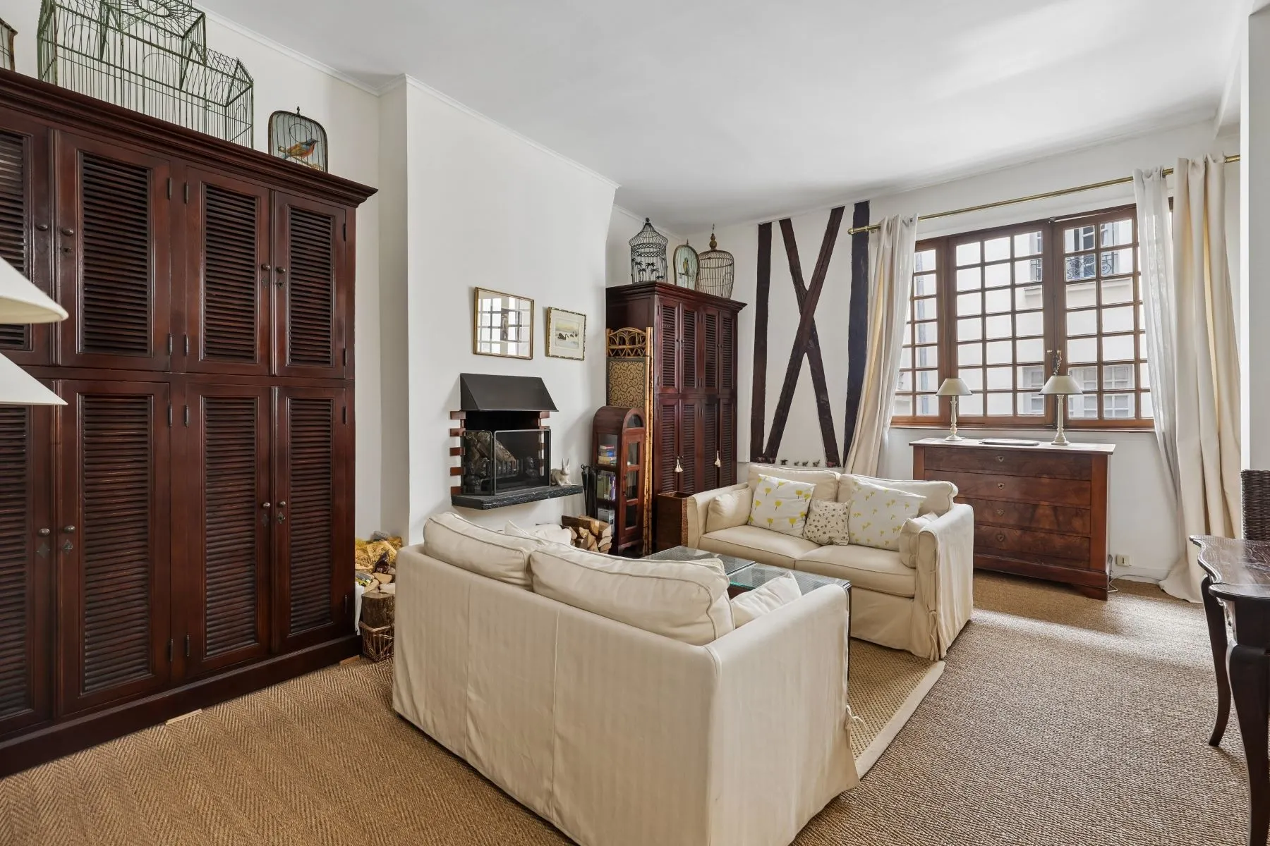 Comfortable sitting room framed by original dark timber beams