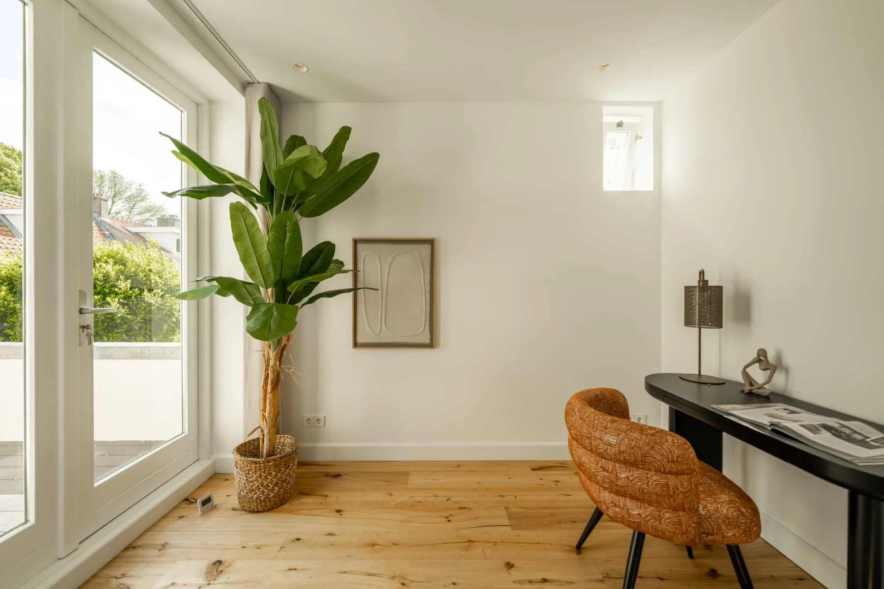 Flexible third bedroom or home office beside tall terrace windows