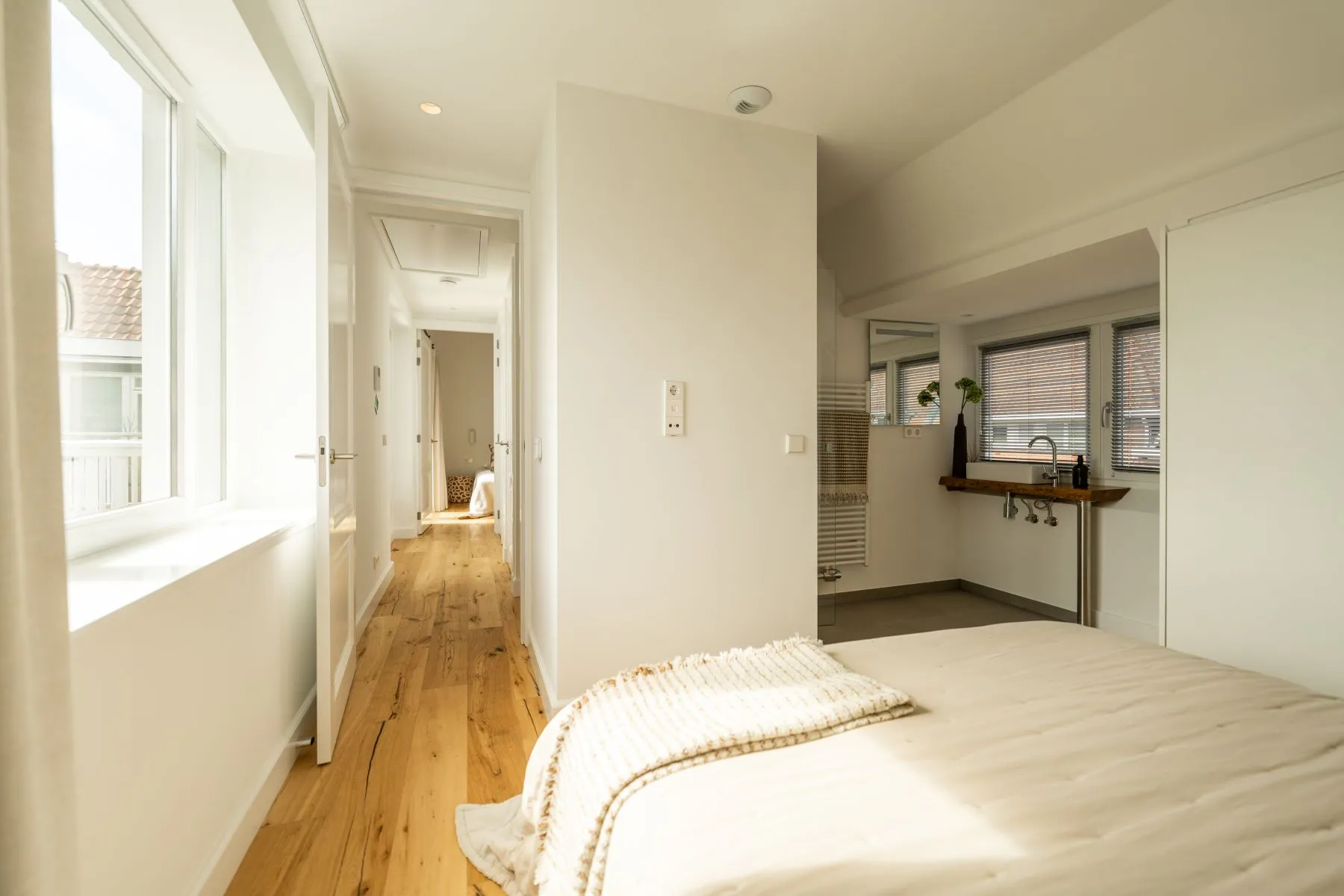 Bedroom corridor with built-in storage and open kitchen view
