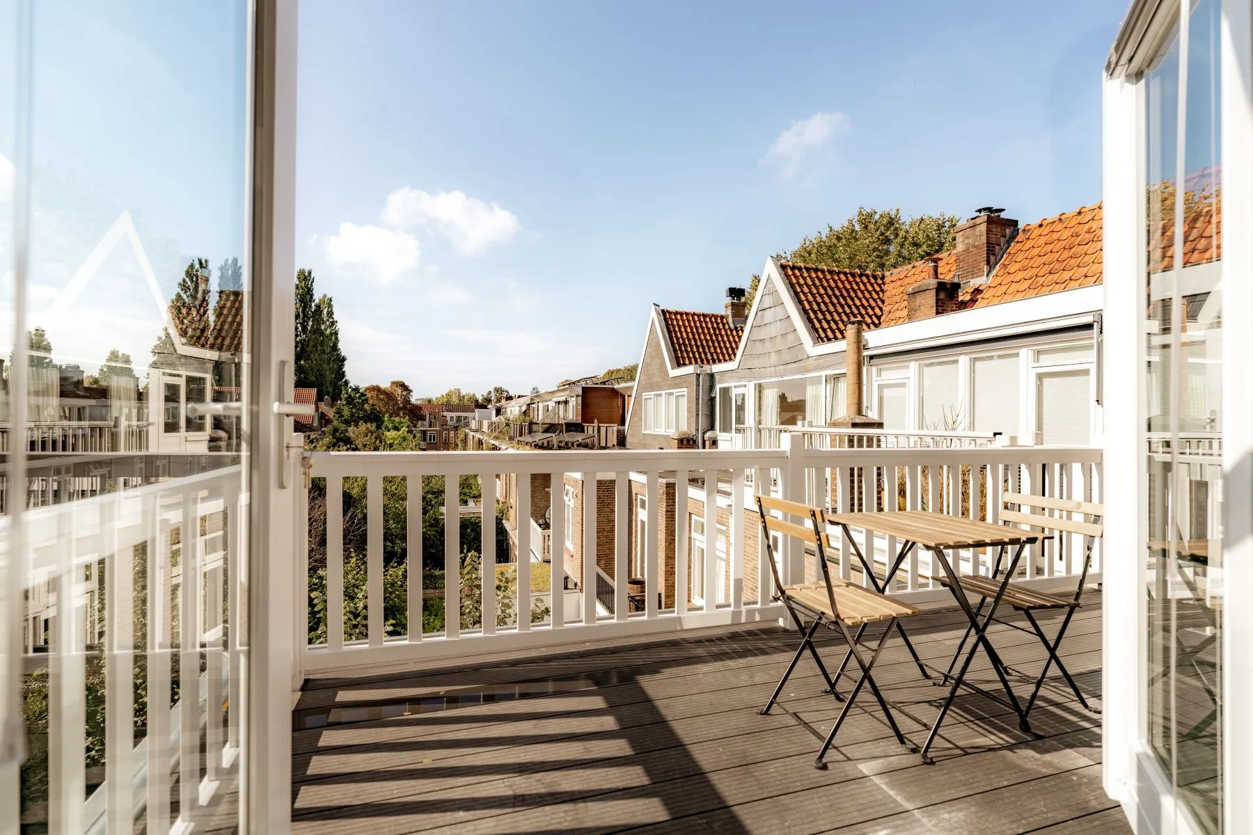 Principal-bedroom terrace with dining table and neighbourhood views