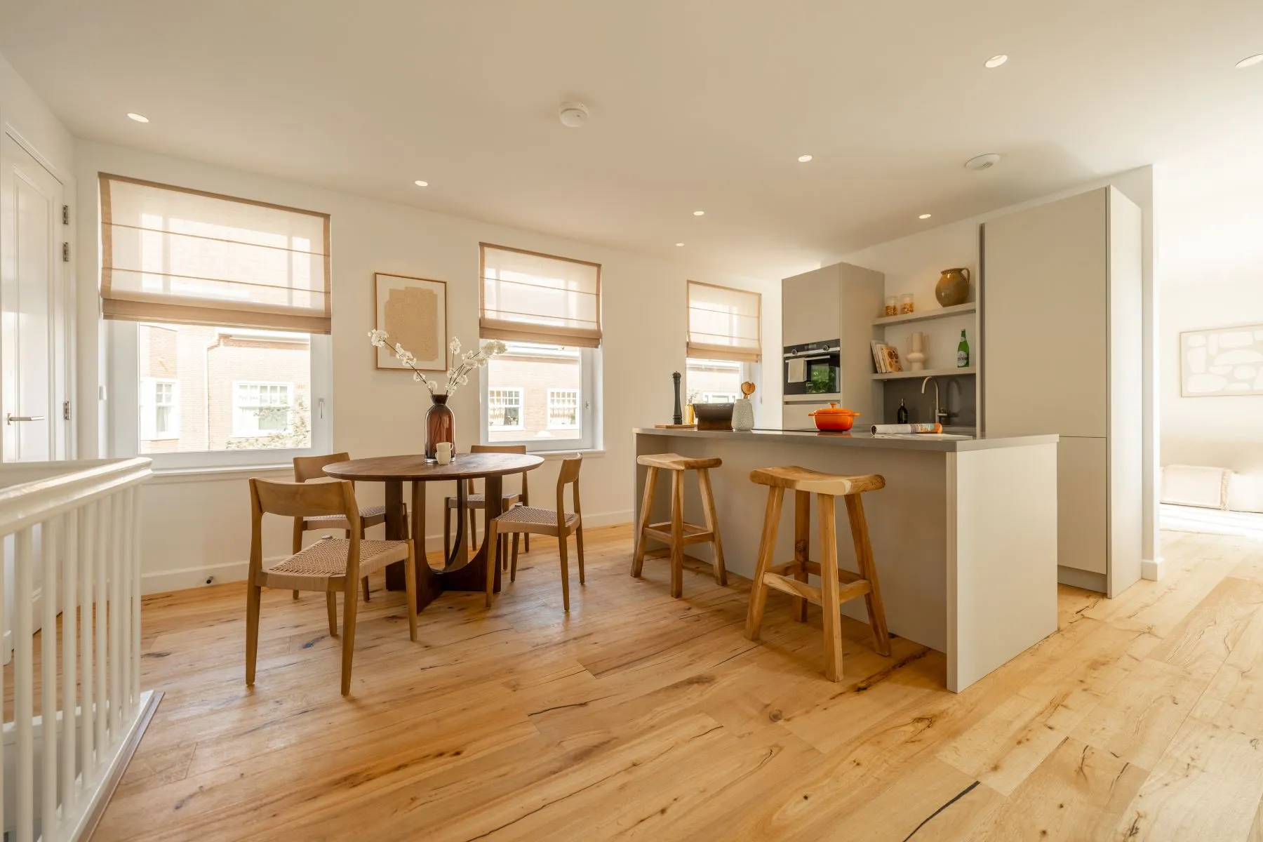 Open-plan kitchen and dining area with pale timber flooring