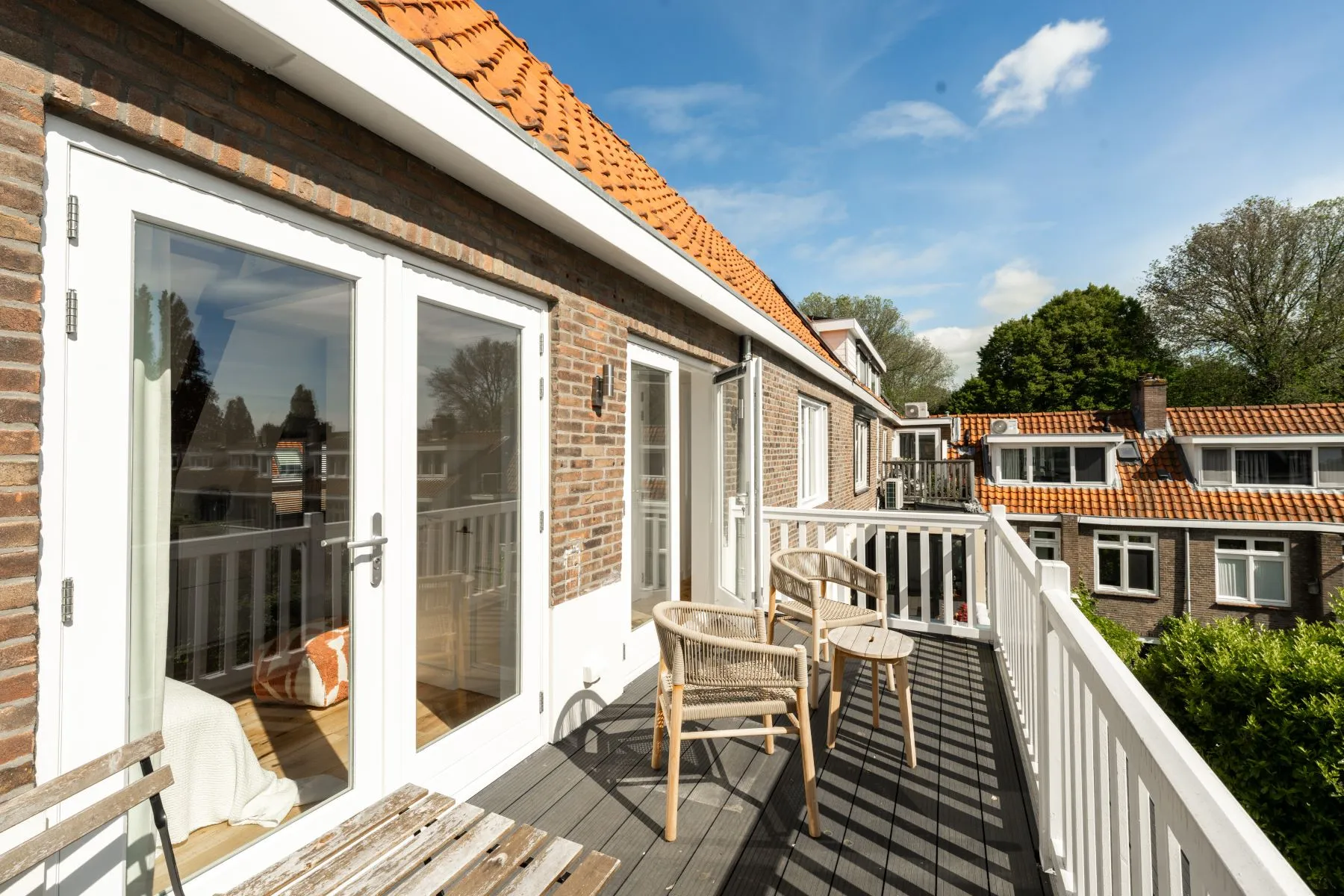 Furnished private terrace framed by Watergraafsmeer rooftops