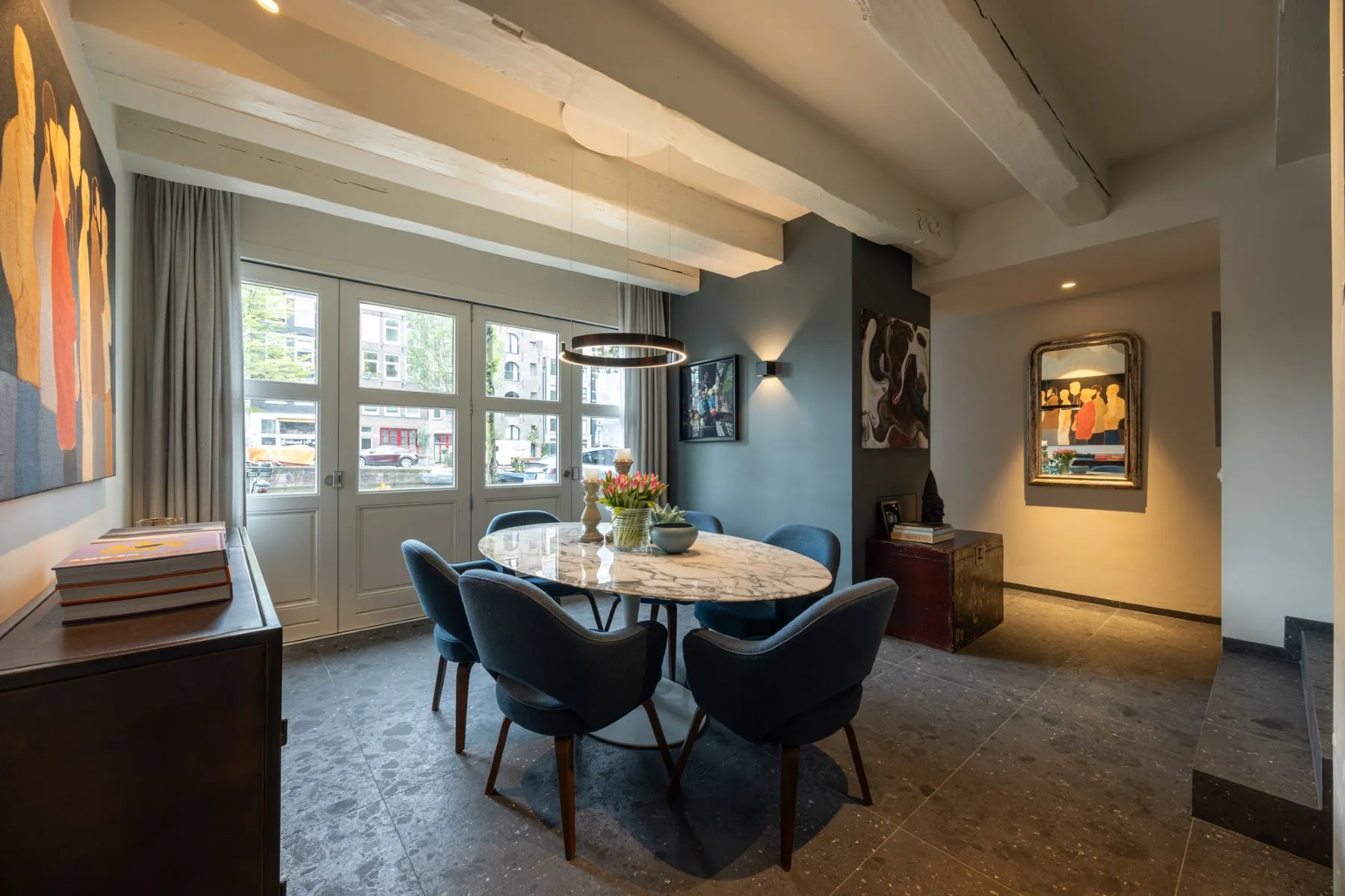 Canal-facing dining room with exposed beams on Prinsengracht