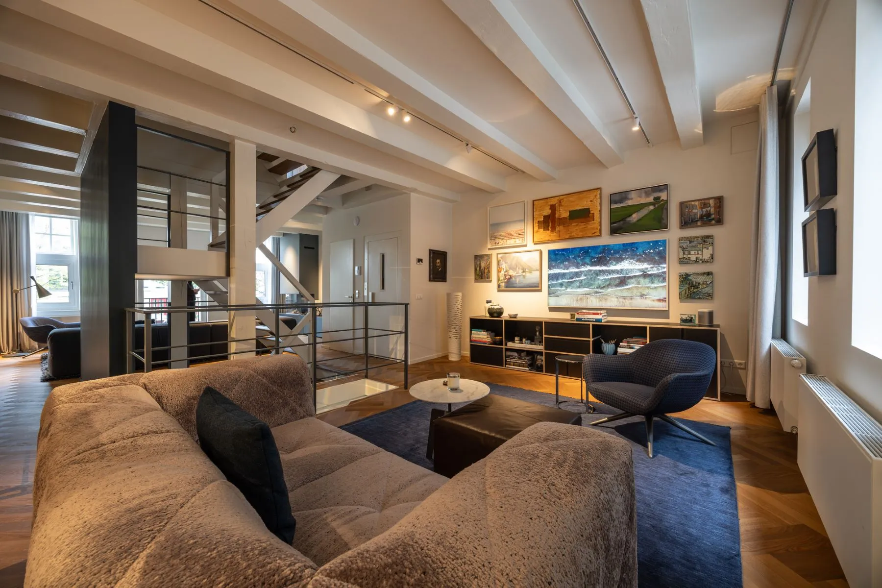 Main lounge with contemporary art glass partitions and canal light