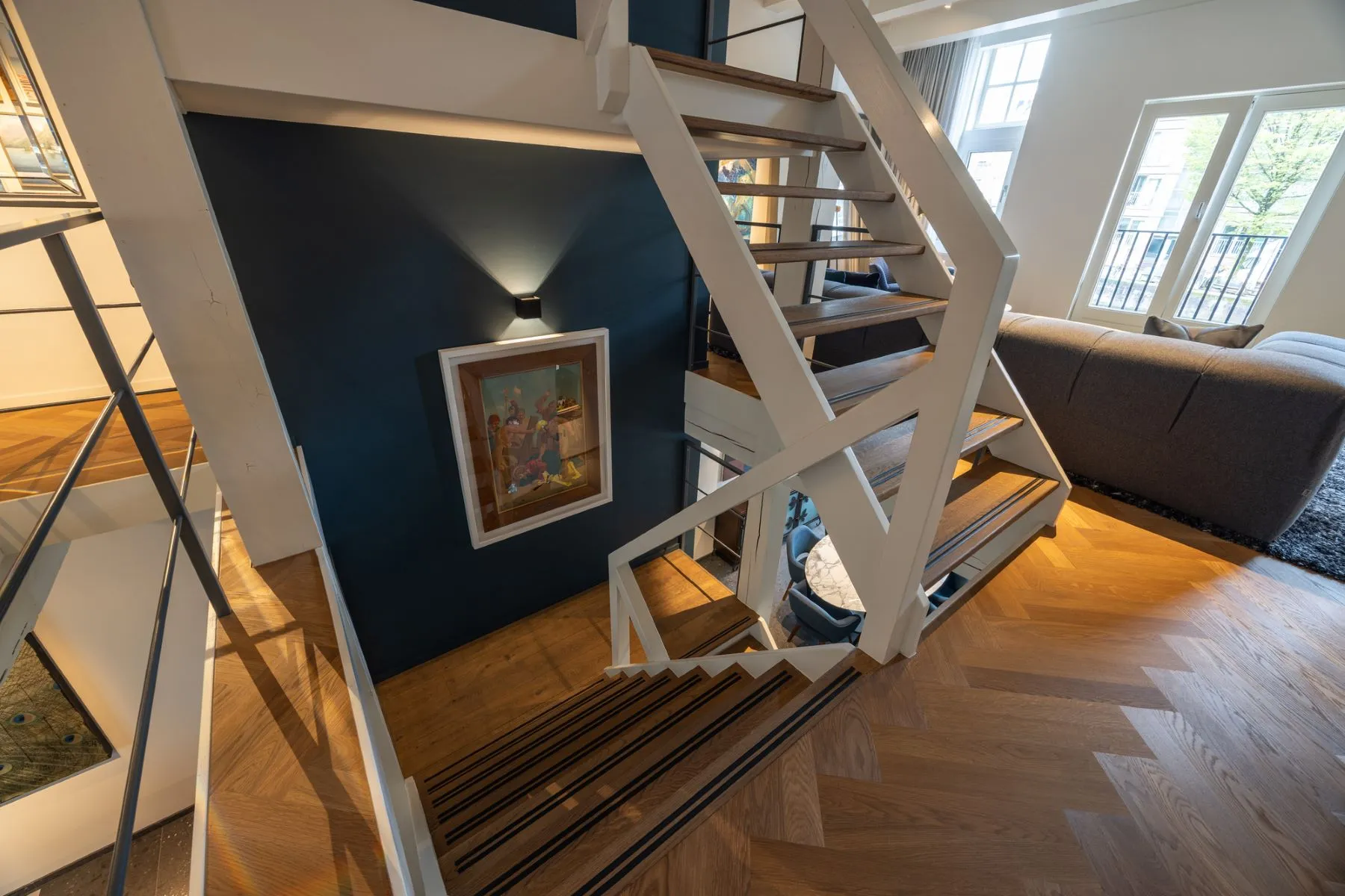 Open staircase connecting the reception and private bedroom levels