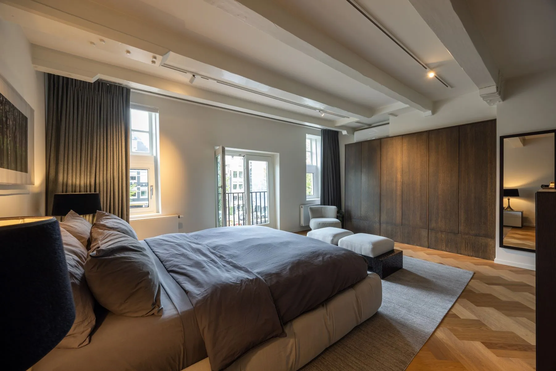 Luxurious principal bedroom with French doors and fitted storage