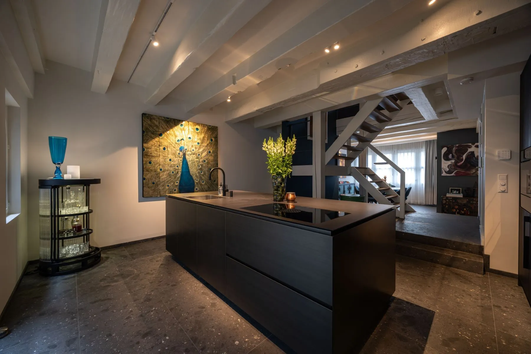 Elegant dining area beside the designer kitchen and open staircase