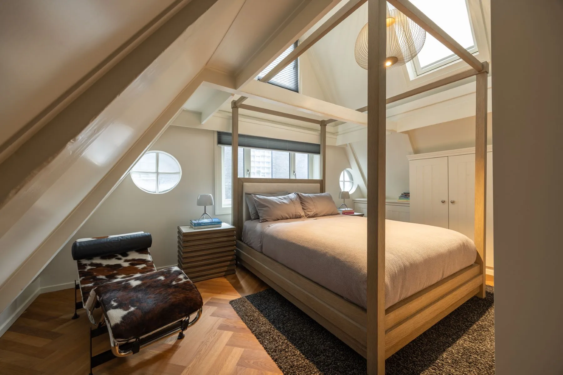 Bright upper bedroom beneath the pitched roof and timber beams