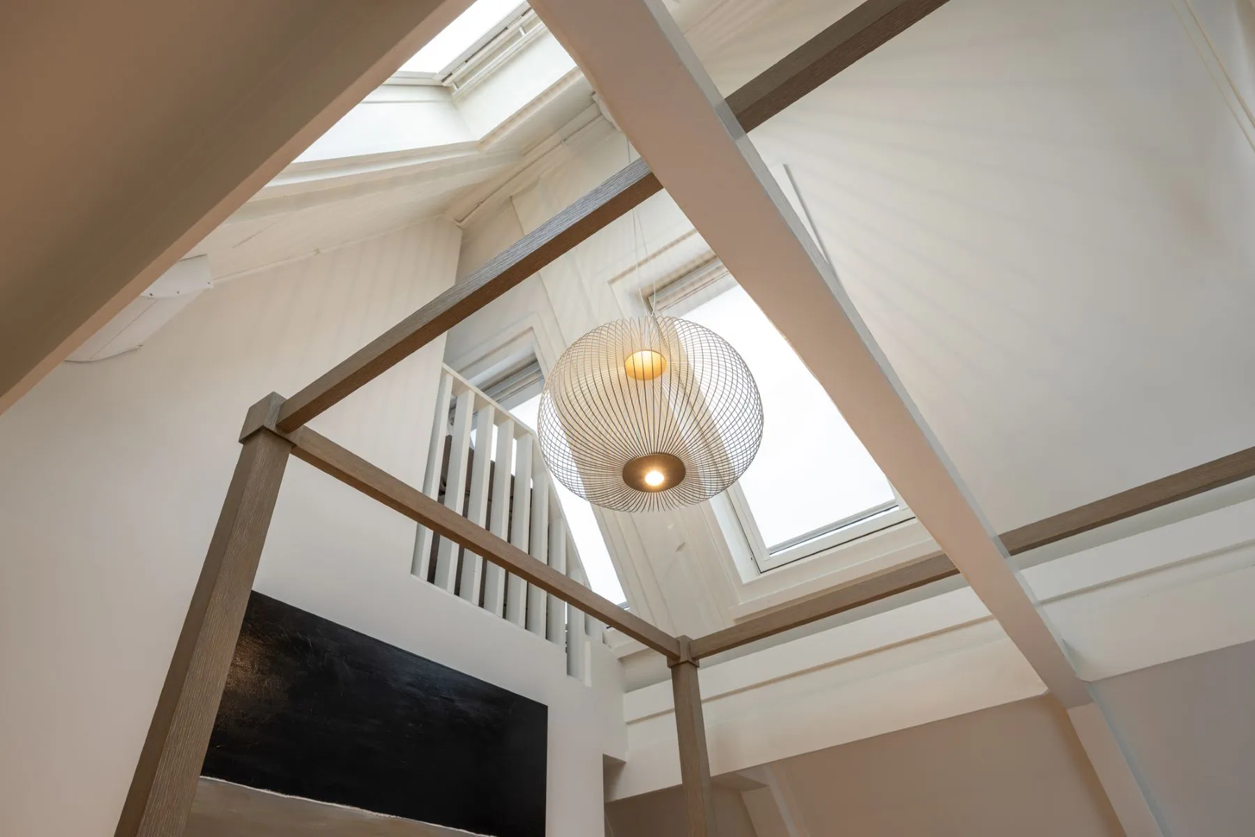 Dramatic skylit stairwell connecting the upper bedroom floor