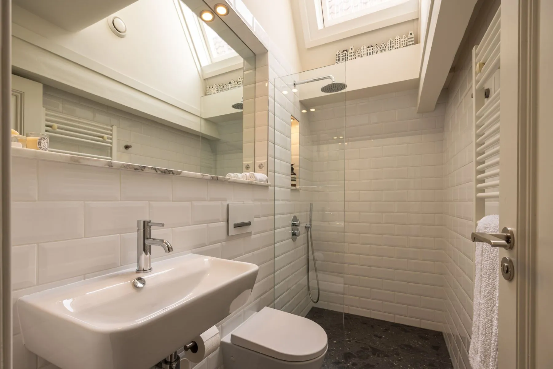 Private upper bathroom with glass shower and white wall tile