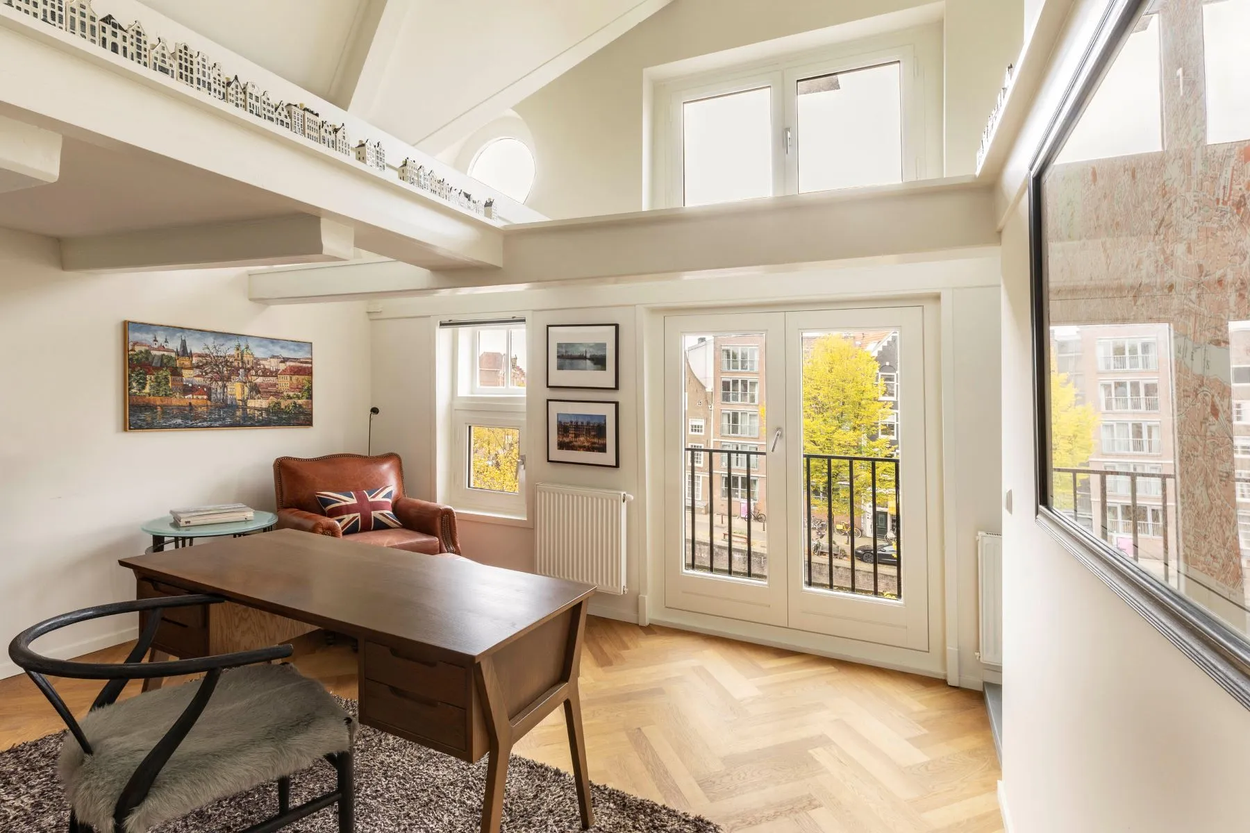 Canal-facing upper lounge and workspace with exposed roof beams