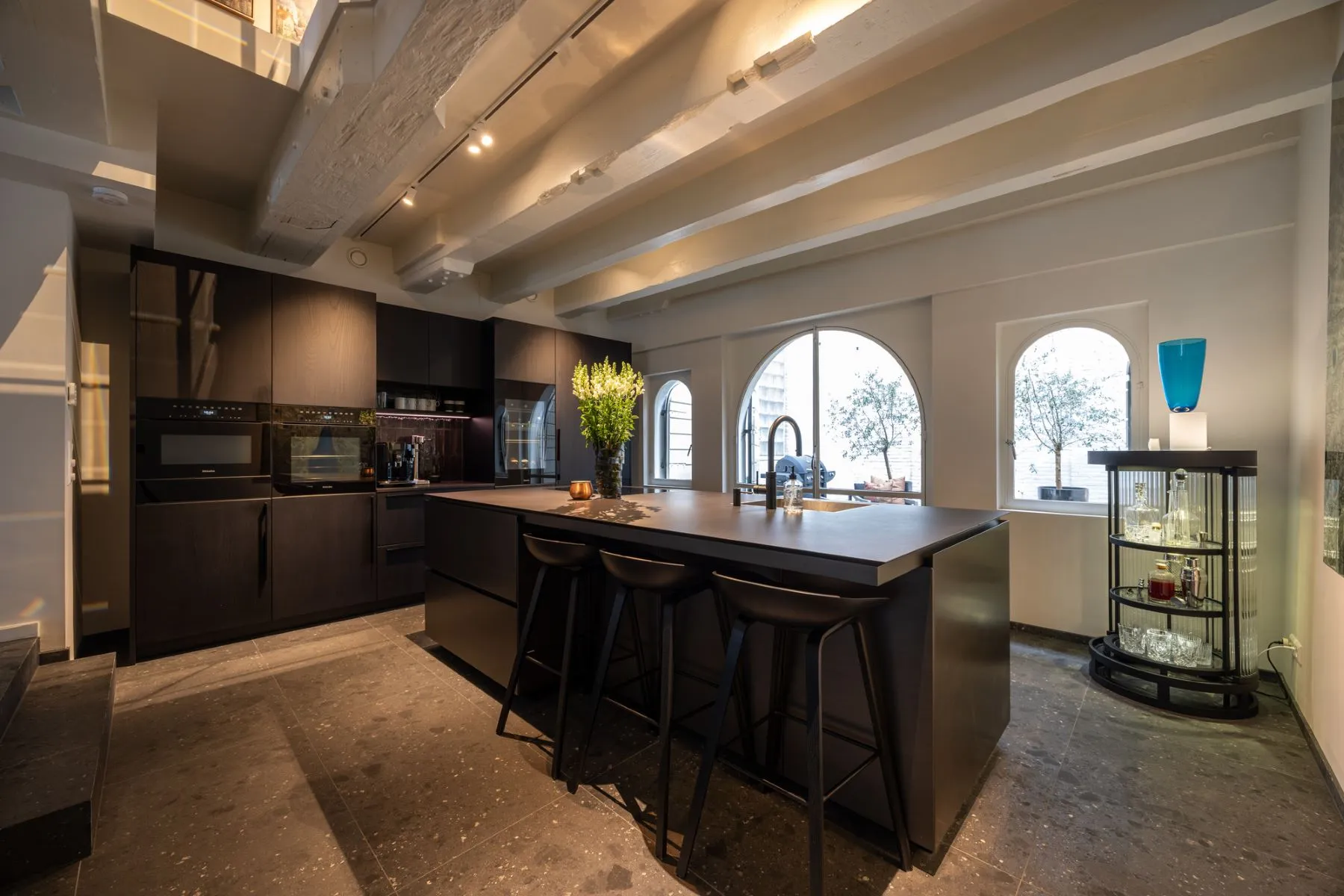 Premium kitchen island with breakfast seating beneath historic beams
