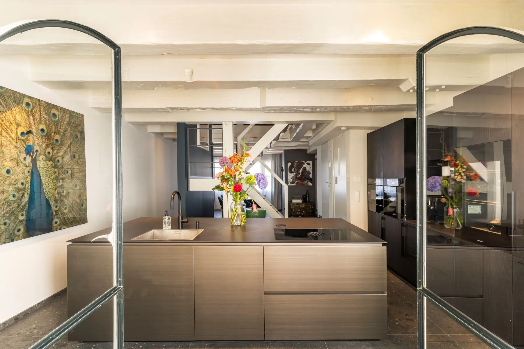 Designer kitchen viewed through the elegant glazed partition