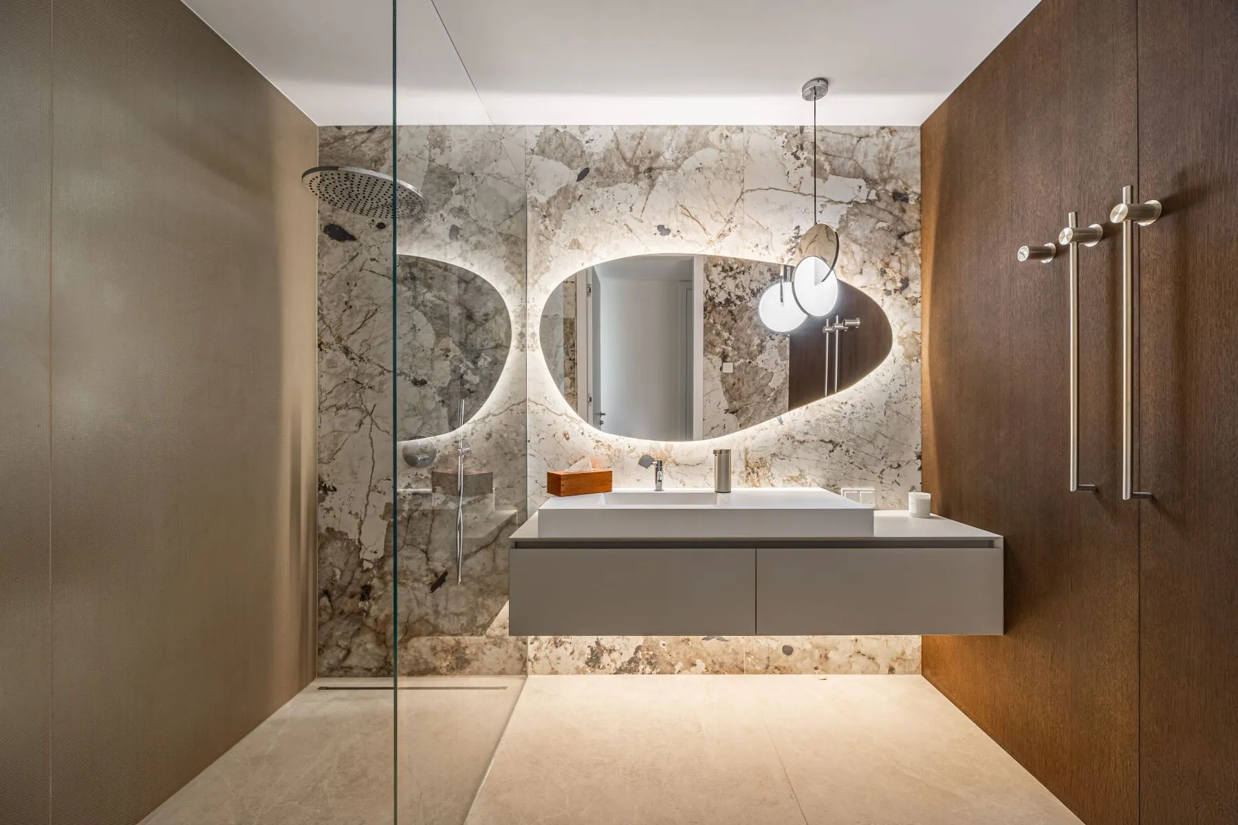 Contemporary shower room with glass enclosure, illuminated mirror and marble-patterned finishes