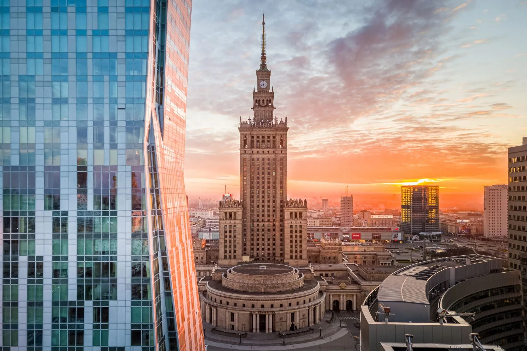 Sunset skyline with the Palace of Culture and Science framed by modern glass towers
