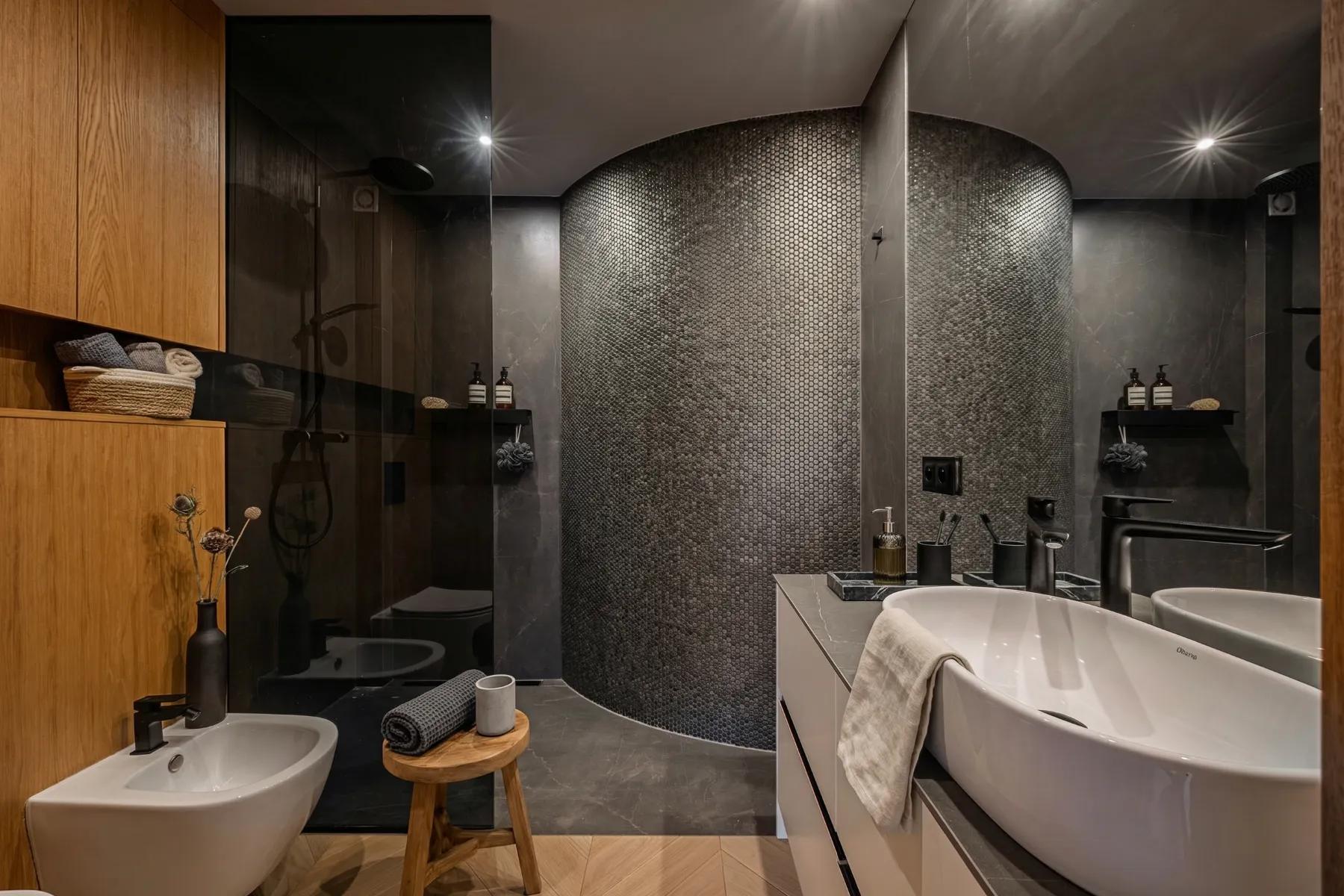 Contemporary dark bathroom with curved glass shower enclosure and timber storage