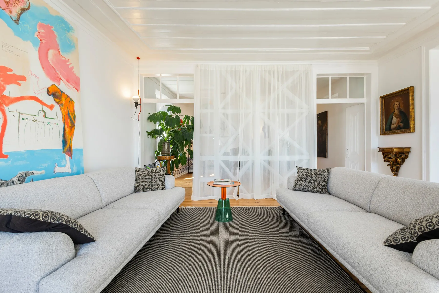 Spacious formal lounge with twin sofas and colourful Lisbon artwork