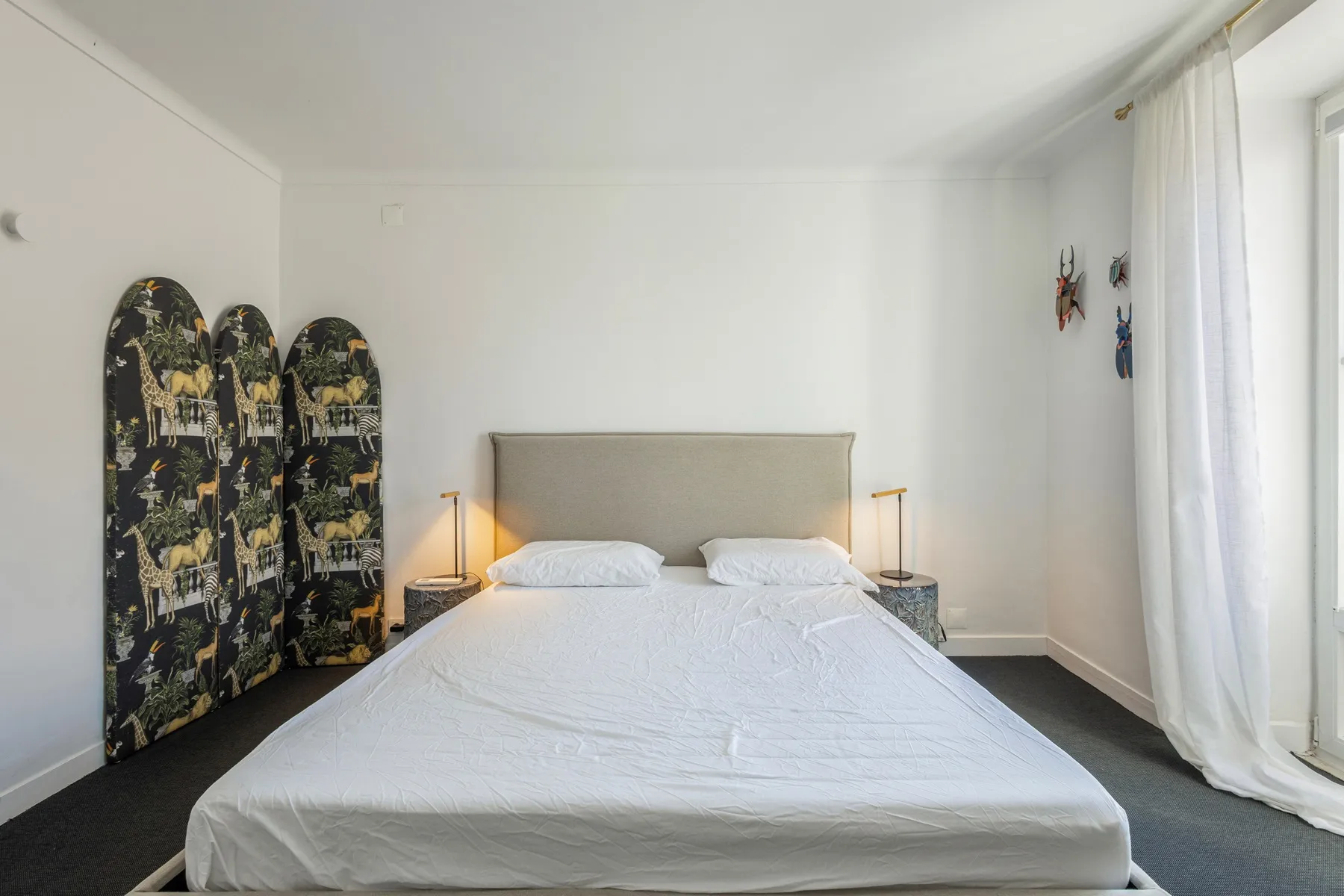 Second double bedroom with decorative screen and soft neutral finishes