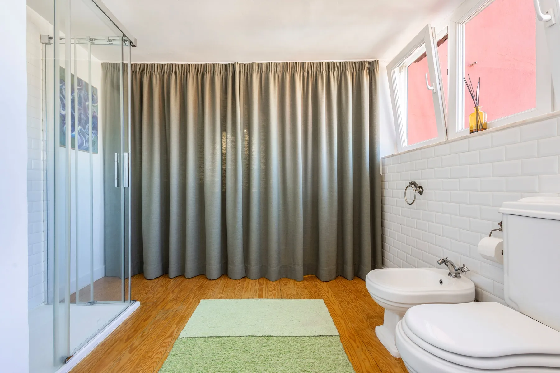 Spacious bathroom with bathtub shower curtain and natural daylight