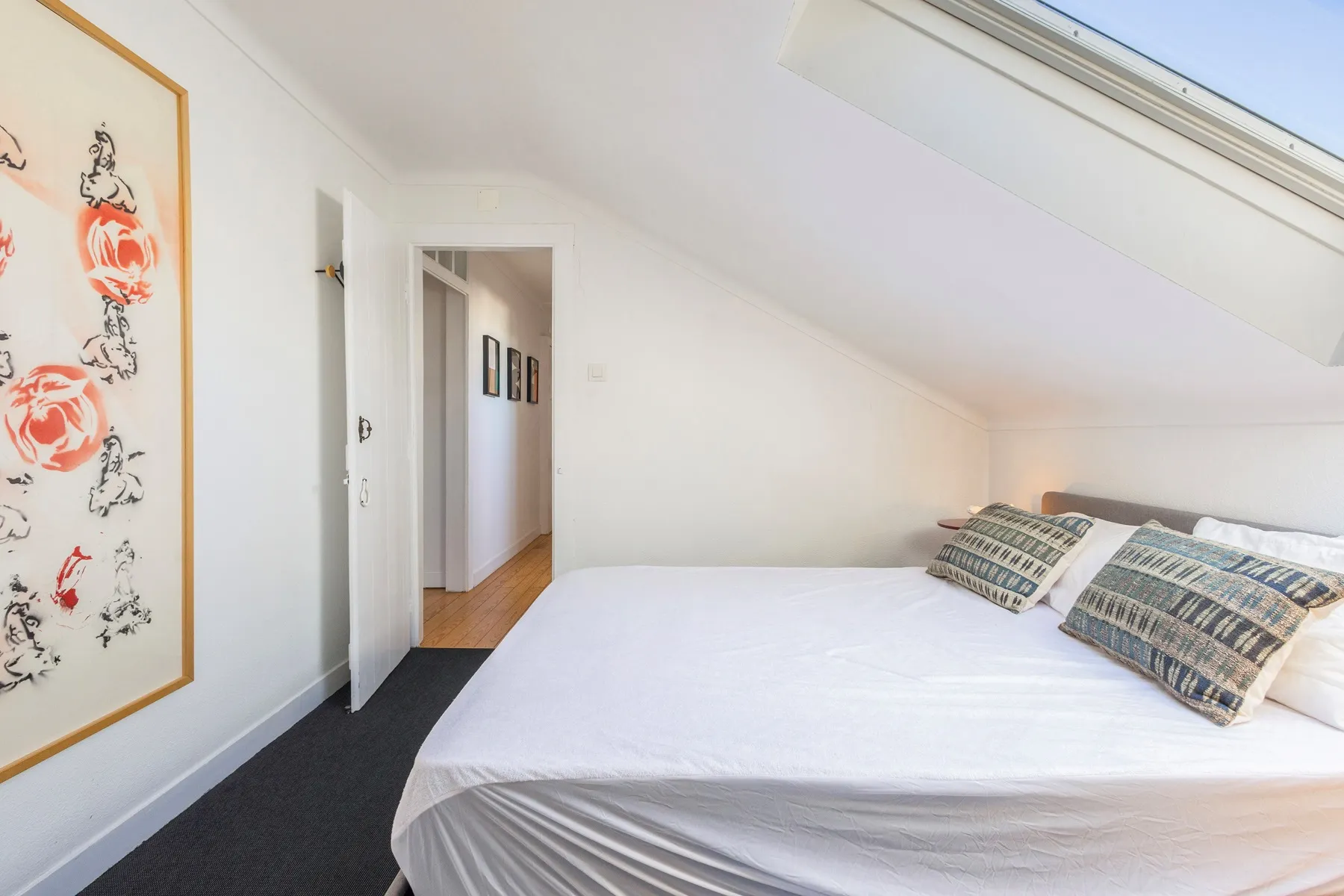 Upper bedroom with double bed artwork and private doorway