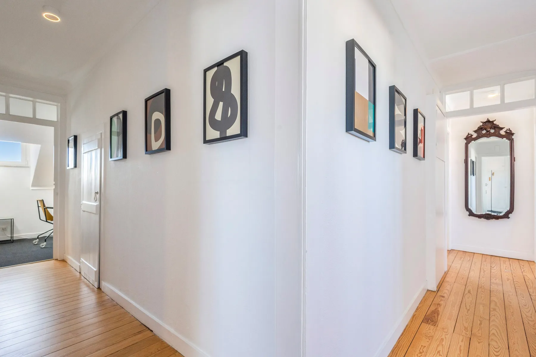 Private bedroom corridor displaying curated contemporary artwork