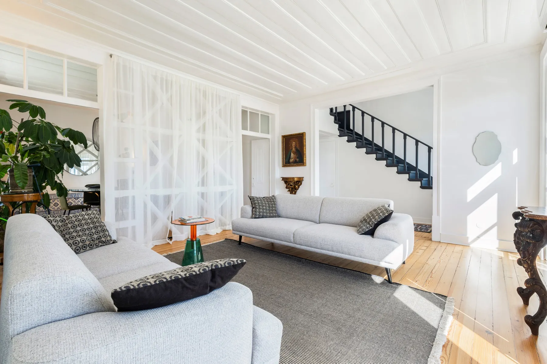 Bright reception room opening toward the internal triplex staircase