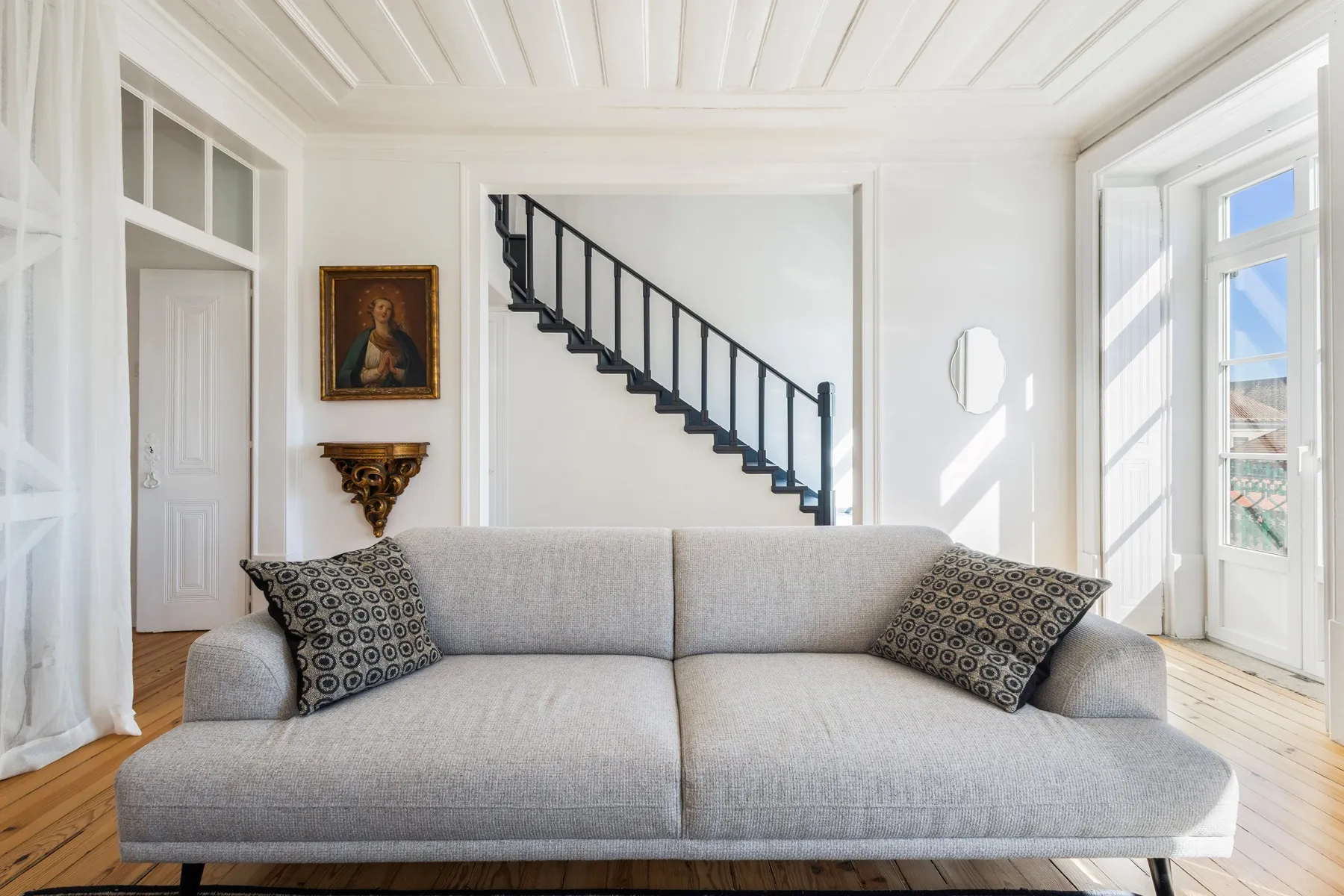 Comfortable sitting area beneath the restored white timber ceiling