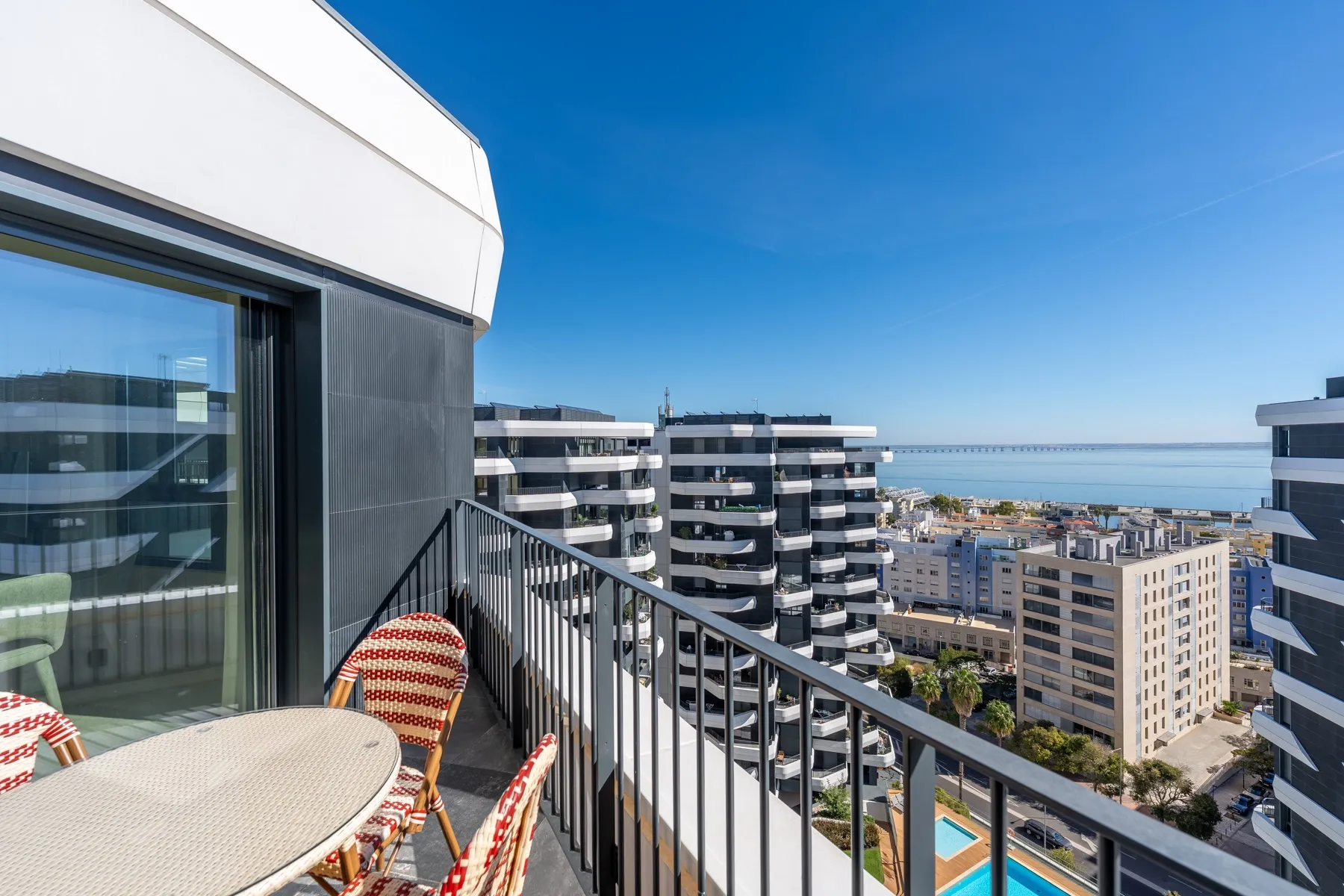 Furnished side balcony with open city and river views