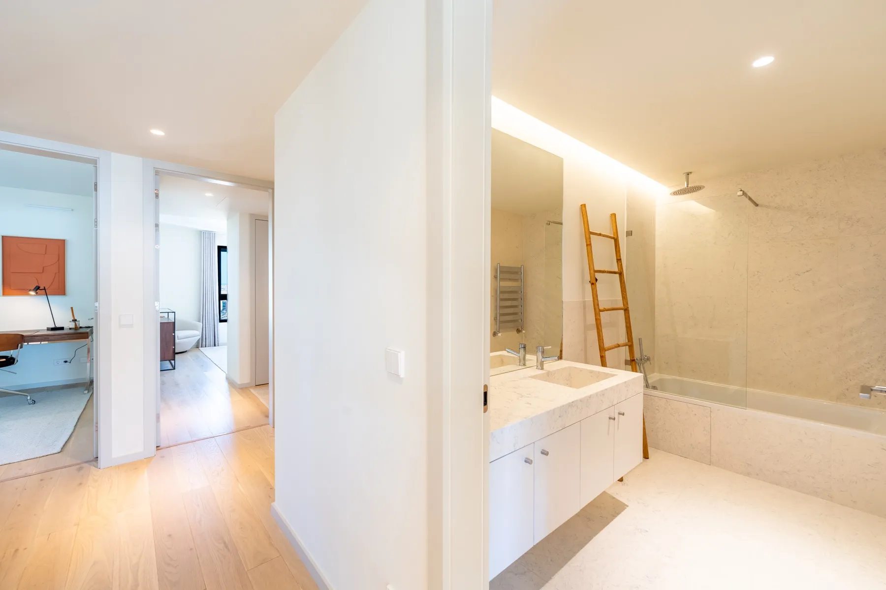 Main bathroom with bathtub double vanity and natural stone surfaces