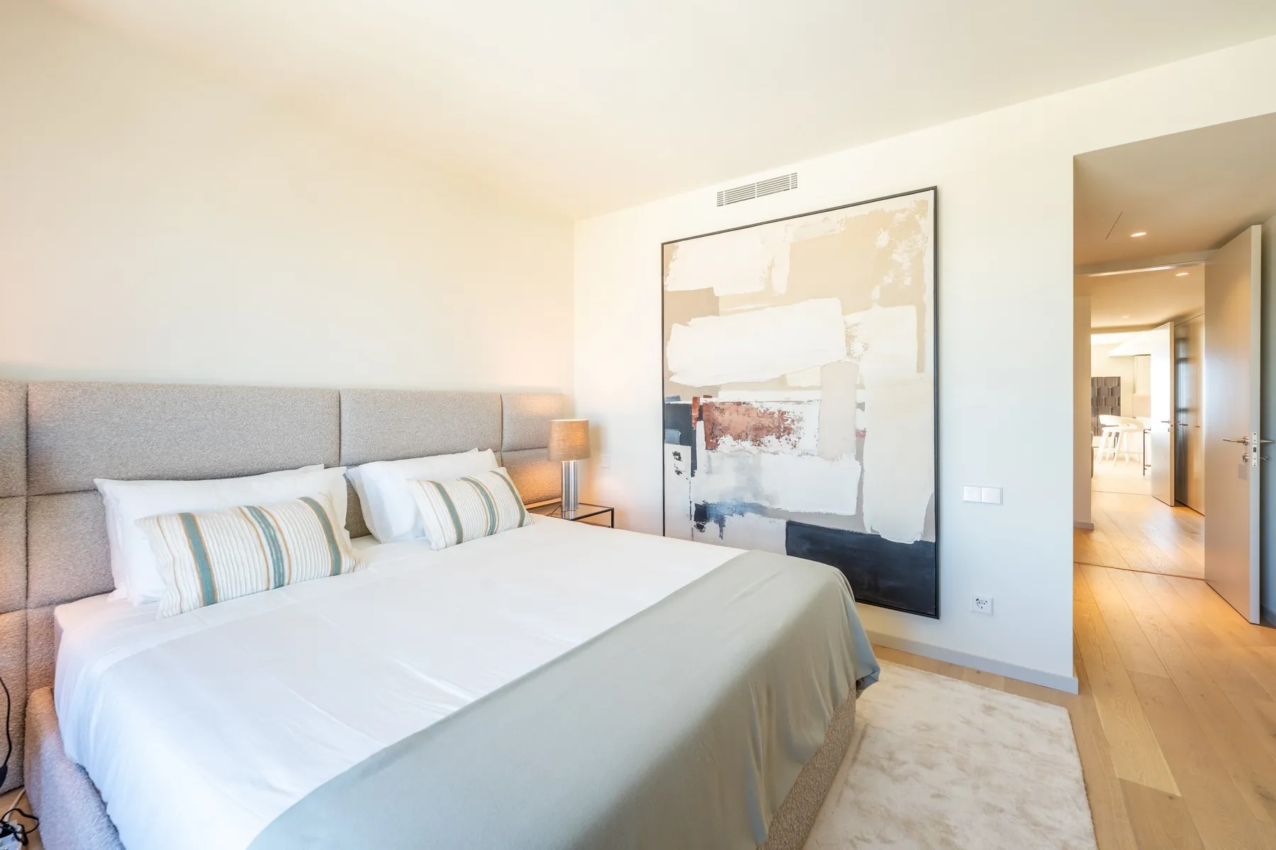 Principal bedroom with upholstered double bed and en-suite access