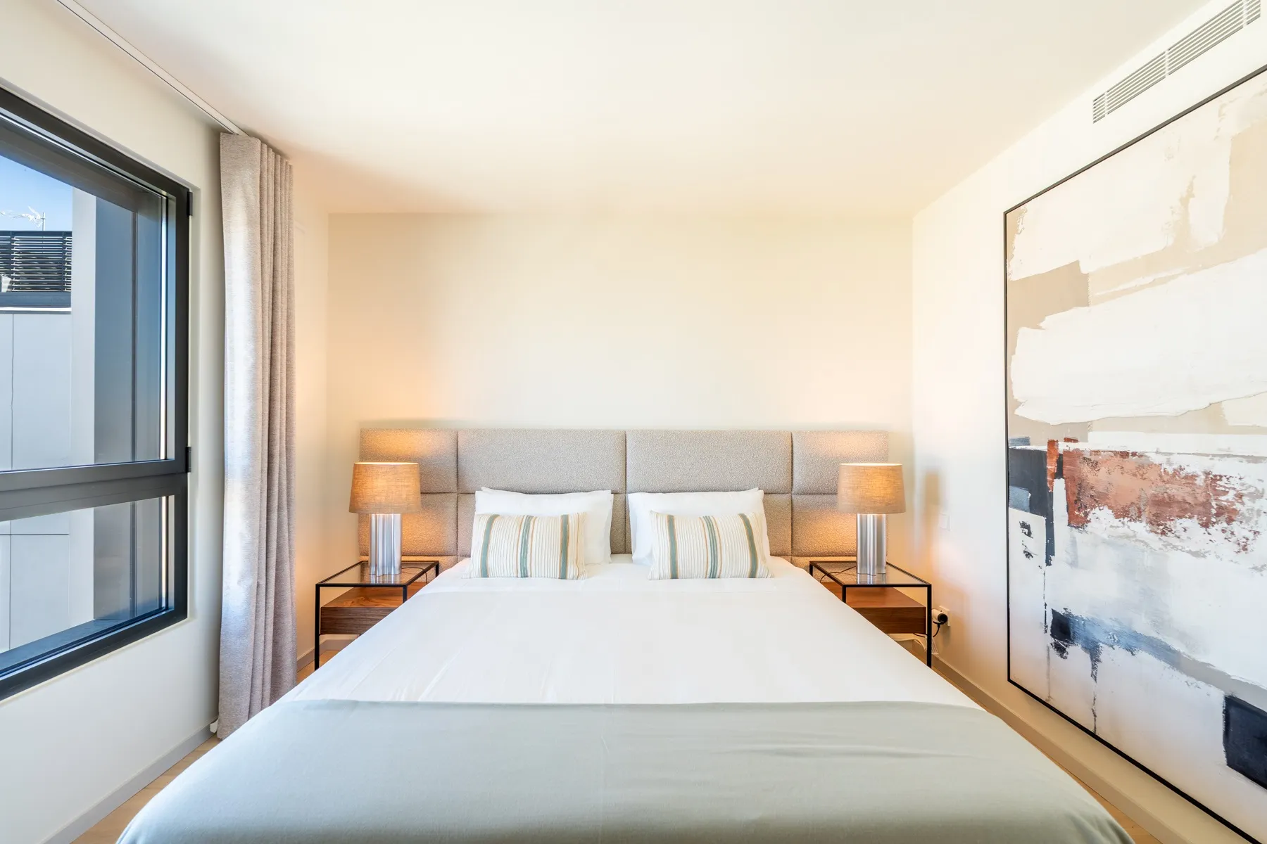 River-facing principal bedroom with contemporary artwork