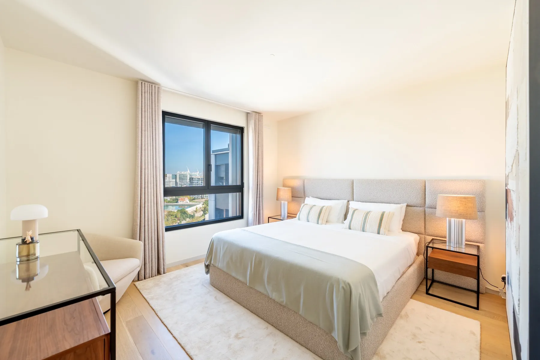 Spacious principal suite with fitted wardrobes and city views