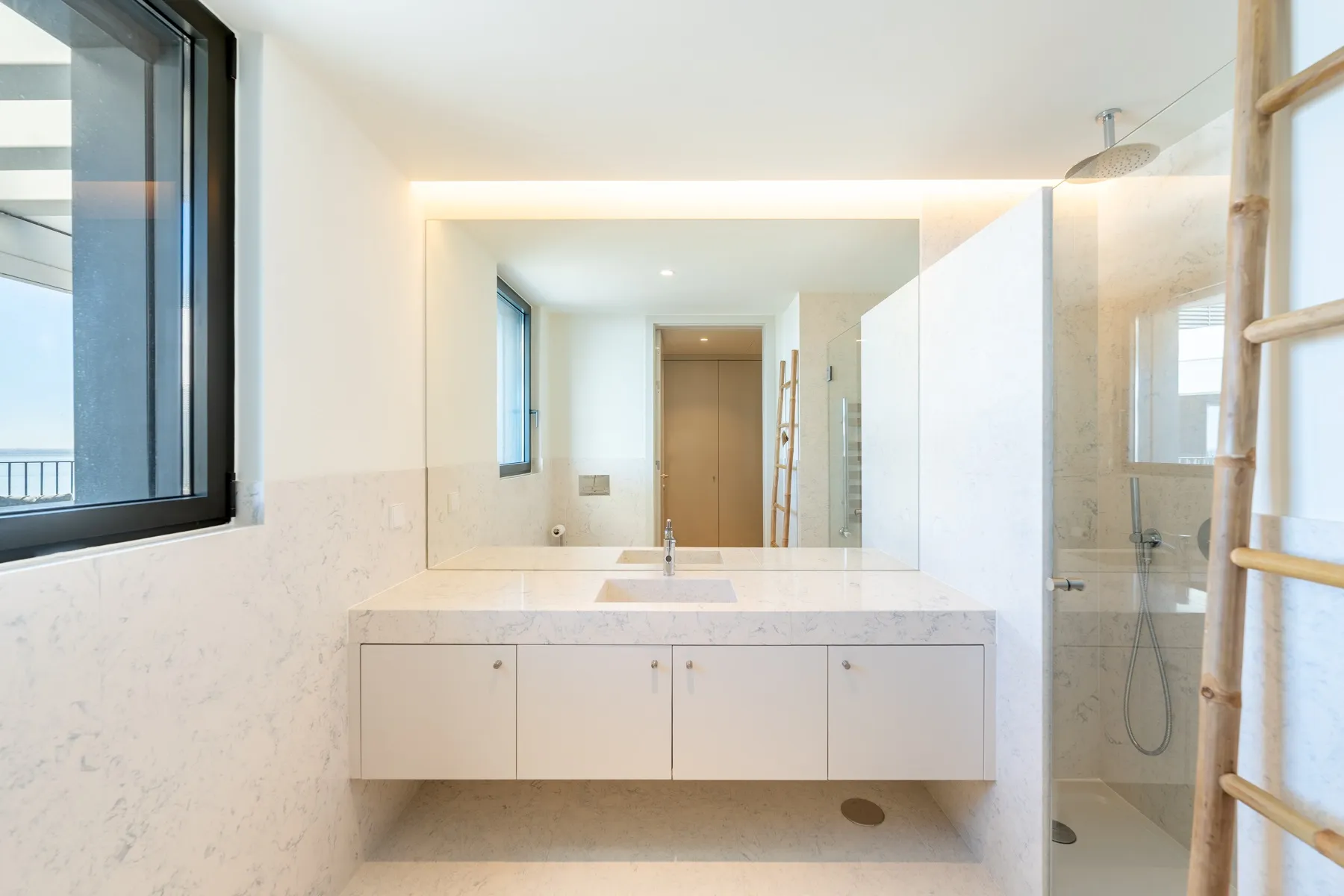 Modern walk-in shower room with wide vanity and wall mirror