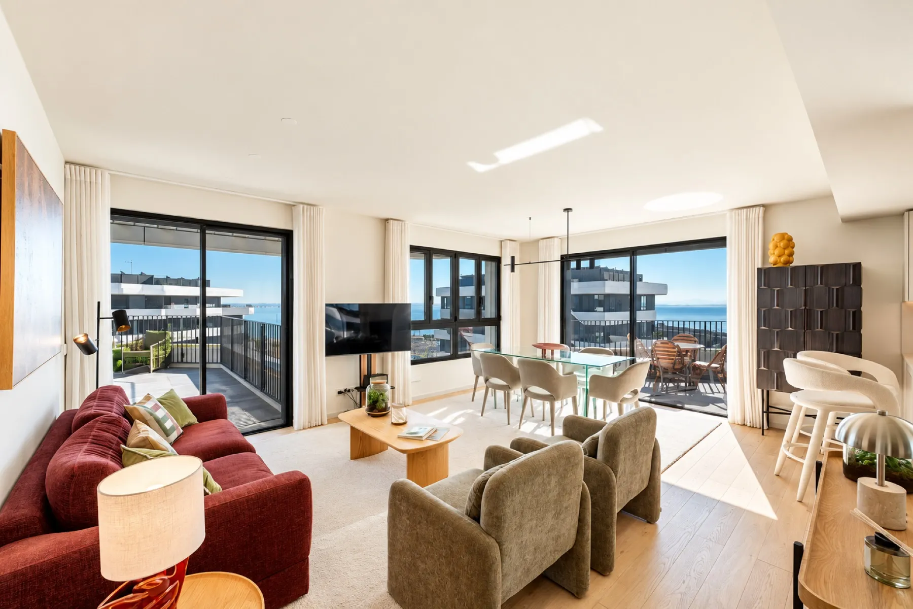 Elegant living room with river-facing windows and contemporary furnishings