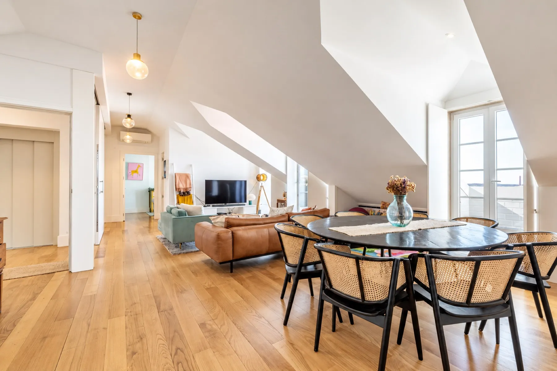 Open living and dining room beneath the characterful roofline