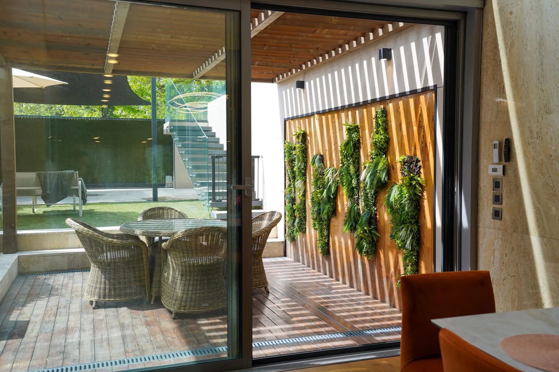 Private courtyard and pergola viewed through the dining-room doors