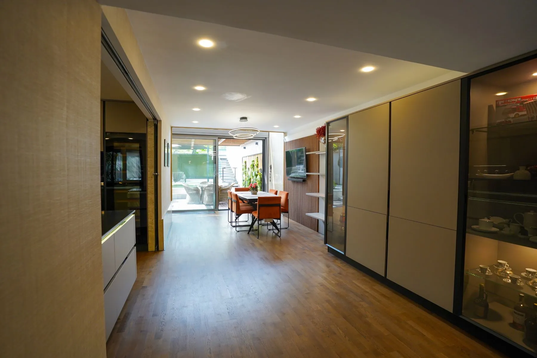 Long open-plan interior connecting the fitted kitchen and garden dining room