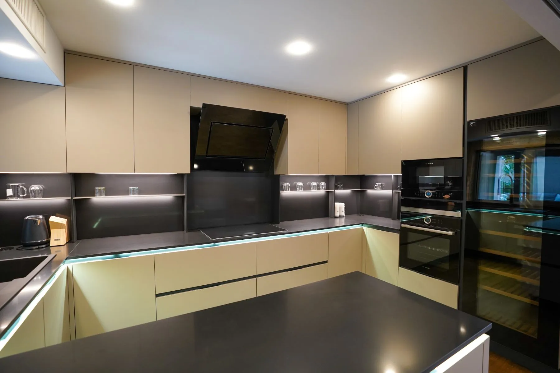 Contemporary fitted kitchen with island, dark worktops and integrated appliances