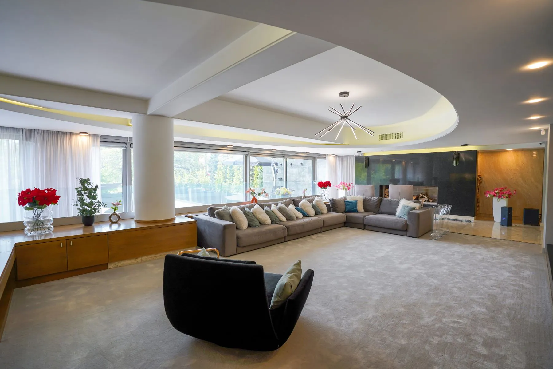 Expansive main living room with sculptural ceiling and multiple seating areas