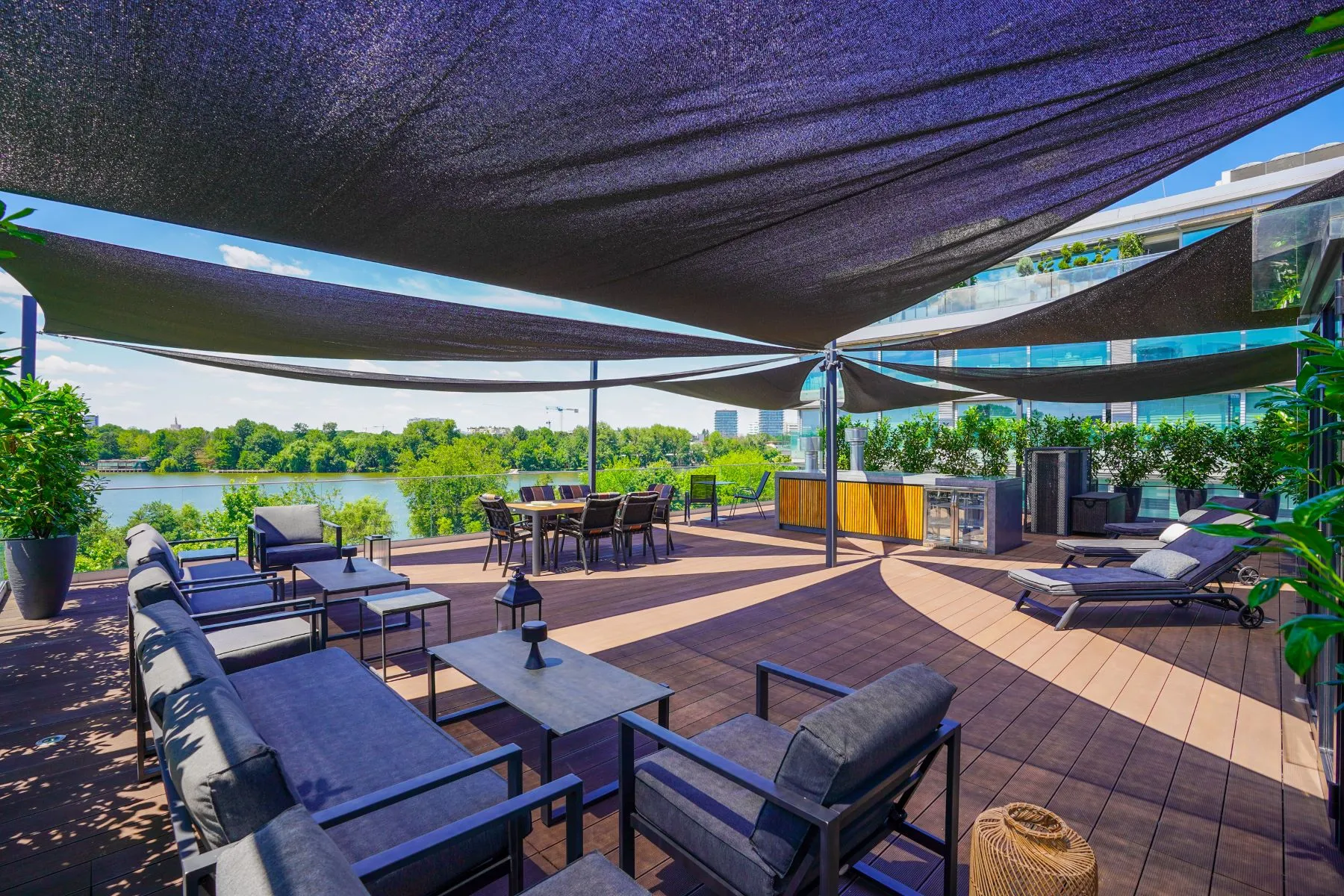 Panoramic rooftop lounge with shaded seating overlooking Lake Floreasca