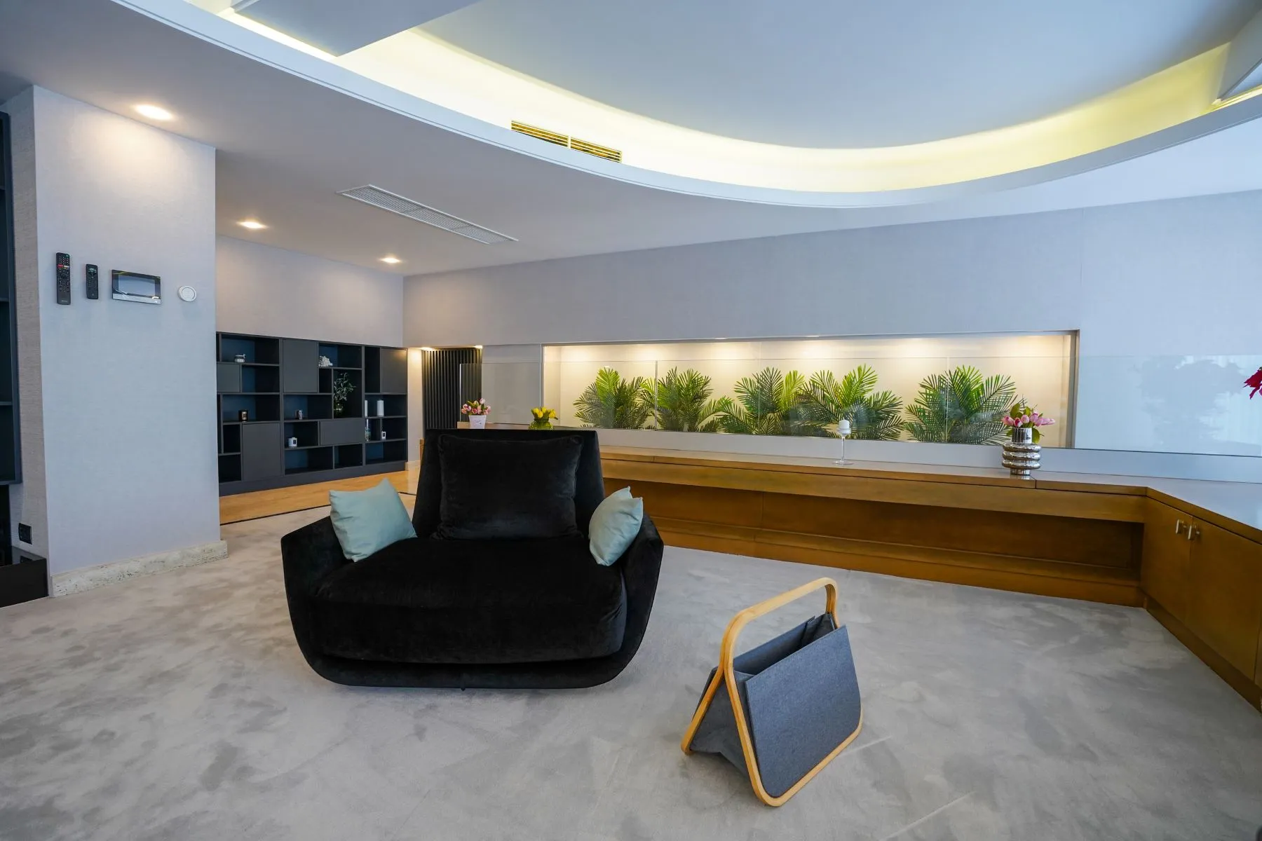 Contemporary lounge chair beneath the illuminated curved ceiling