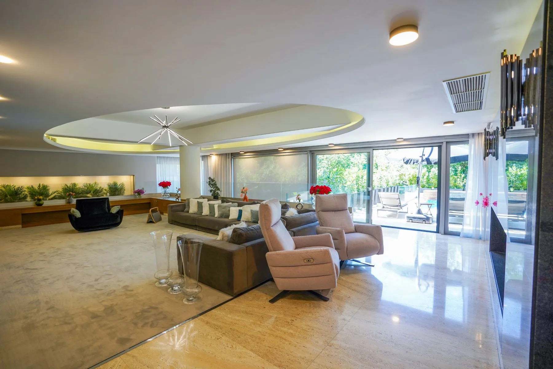 Open main reception room with polished stone floor and layered seating