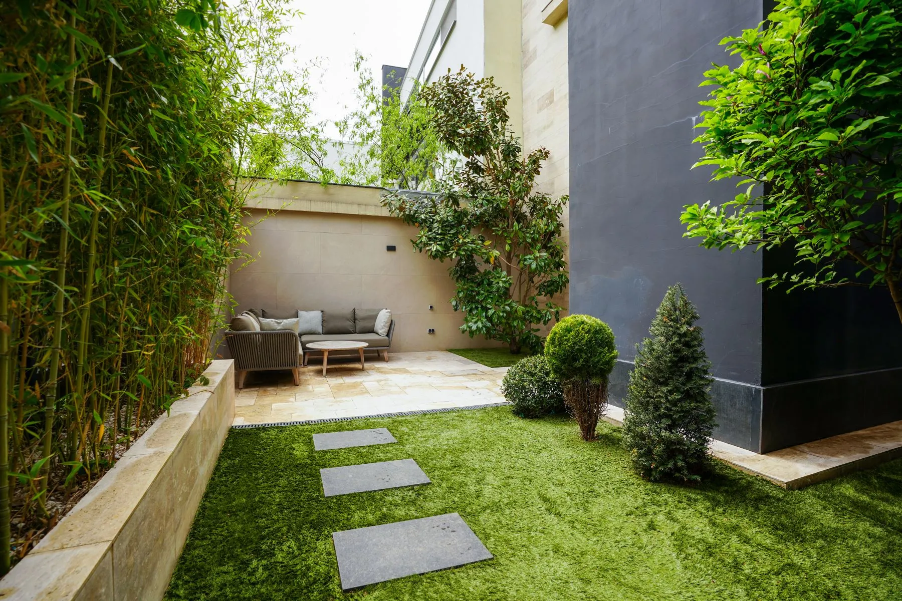 Landscaped side garden with stepping stones and sheltered outdoor seating