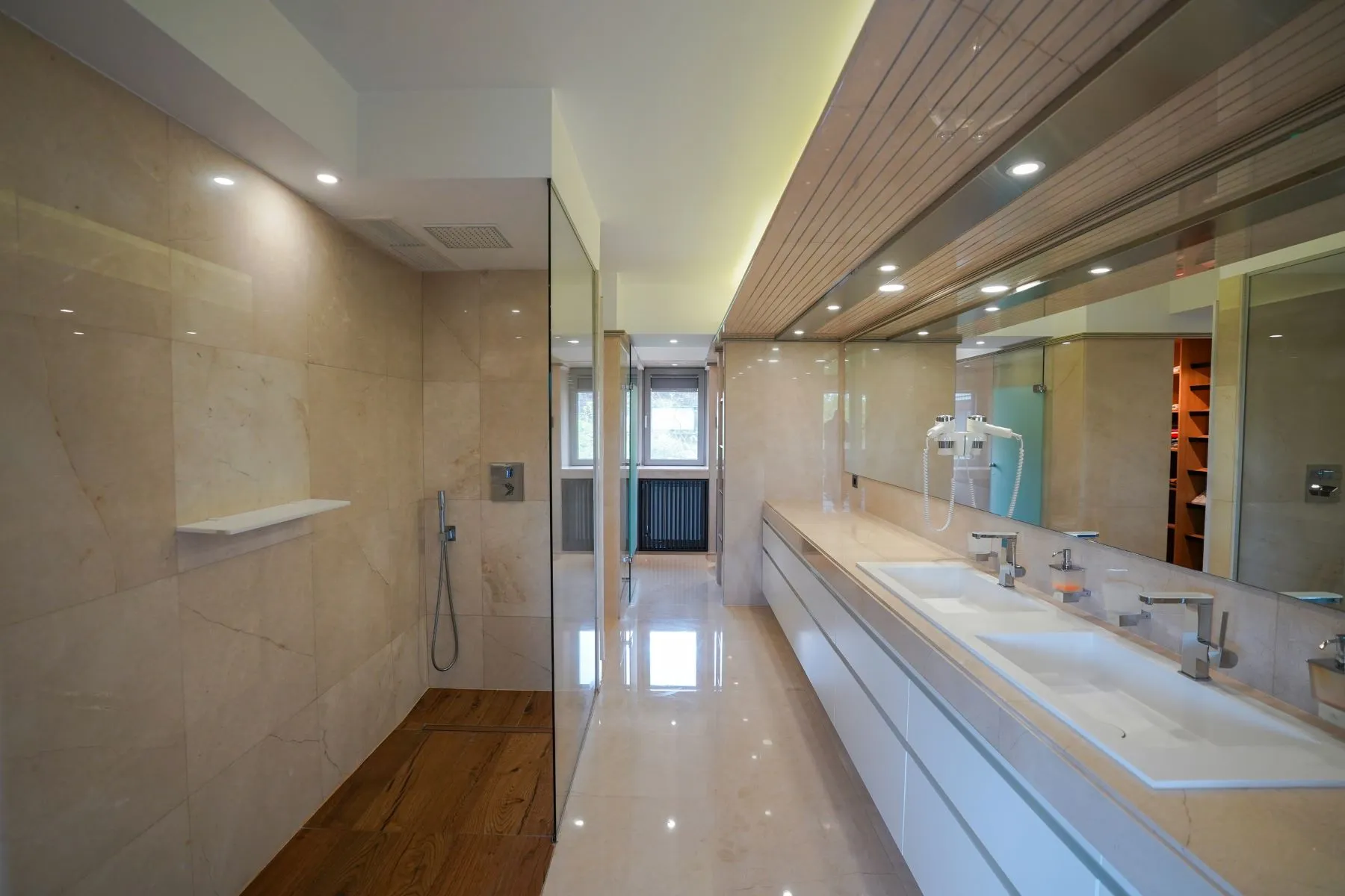 Marble master bathroom with long vanity, twin basins and walk-in shower