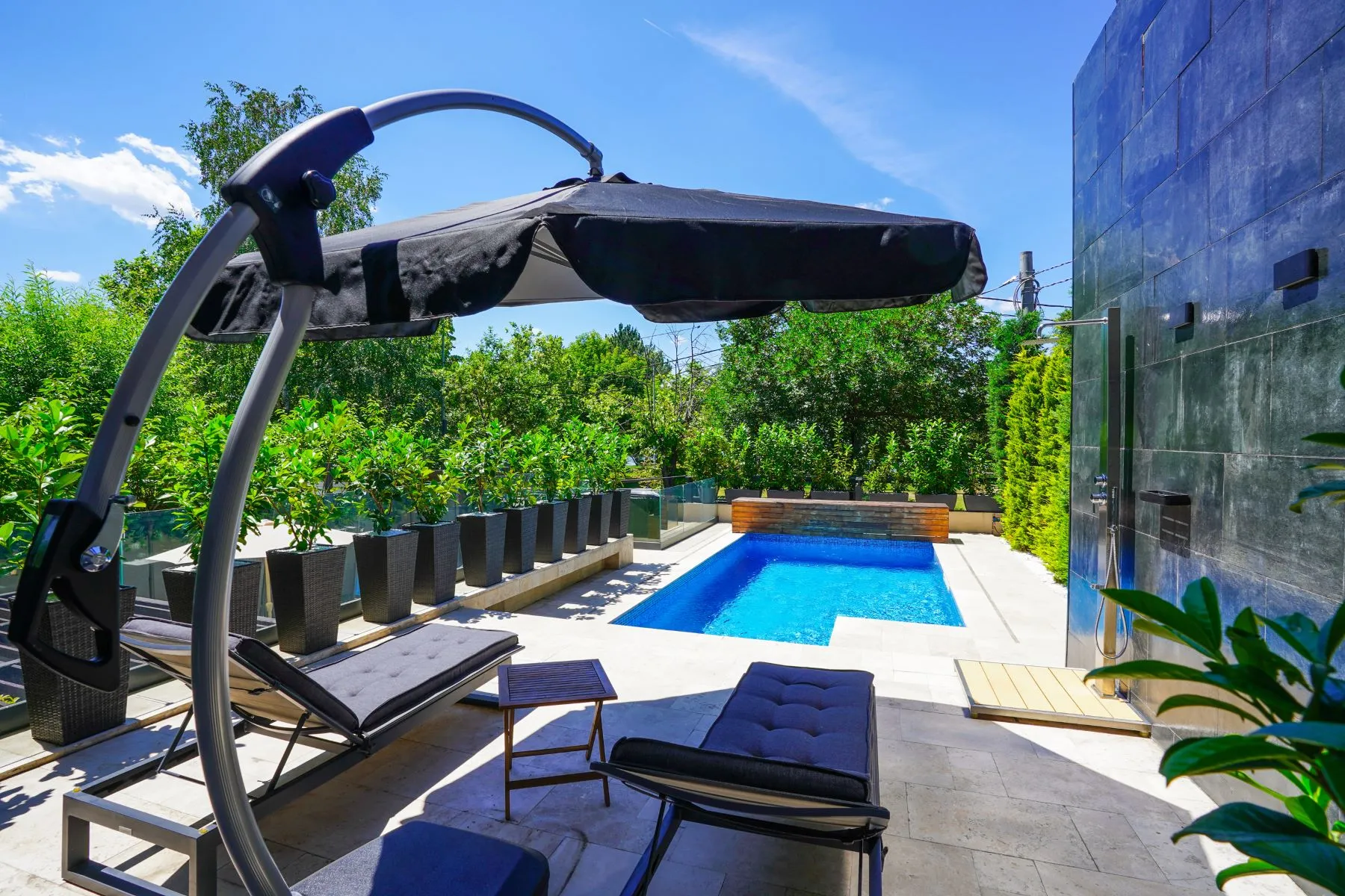Private outdoor pool with sun loungers beside the contemporary villa