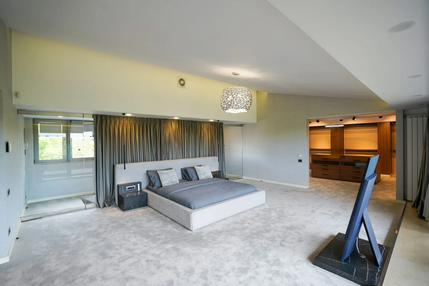 Private upper-floor suite with bedroom, dressing area and soft cove lighting