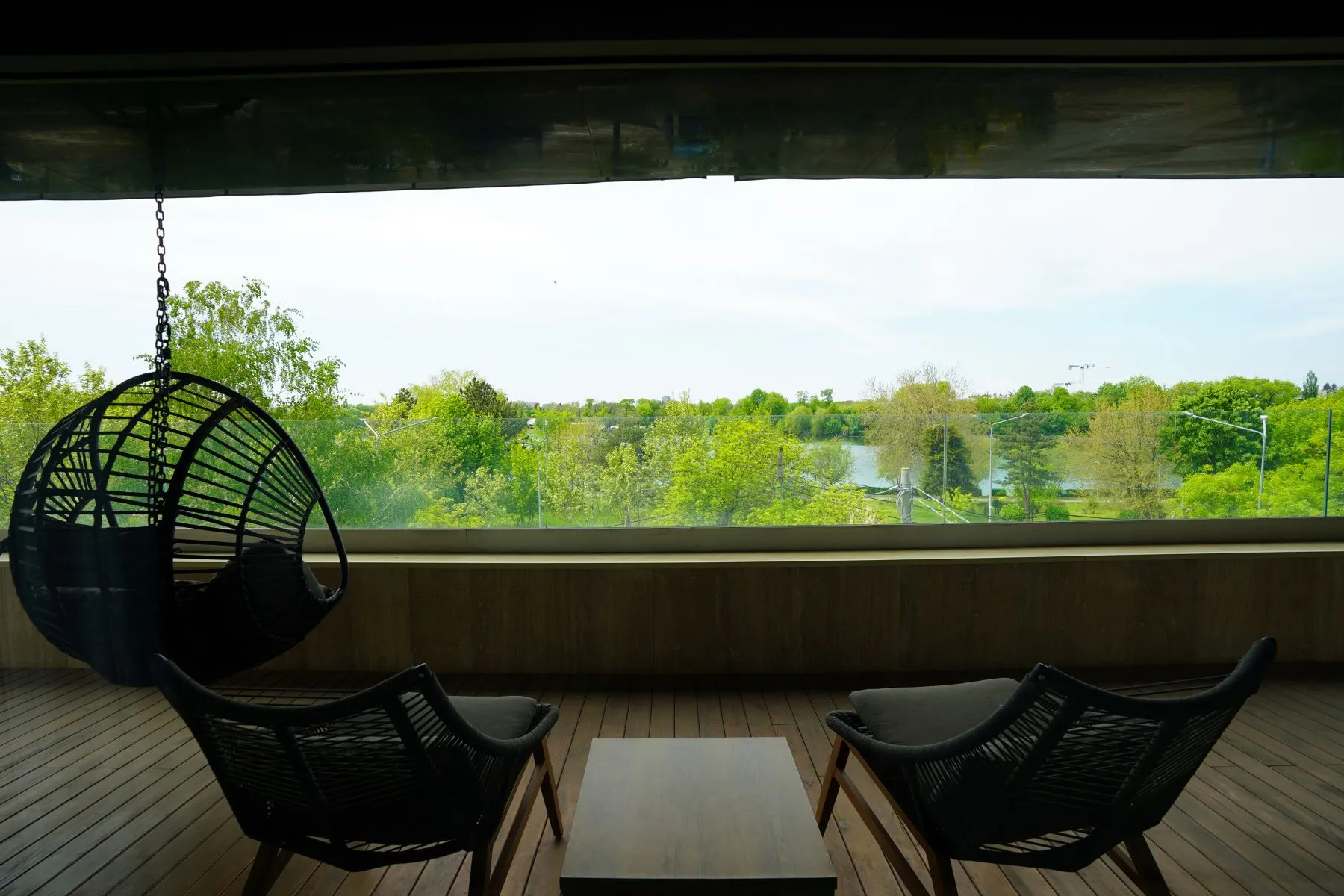 Private master terrace with hanging chair and panoramic Lake Floreasca view