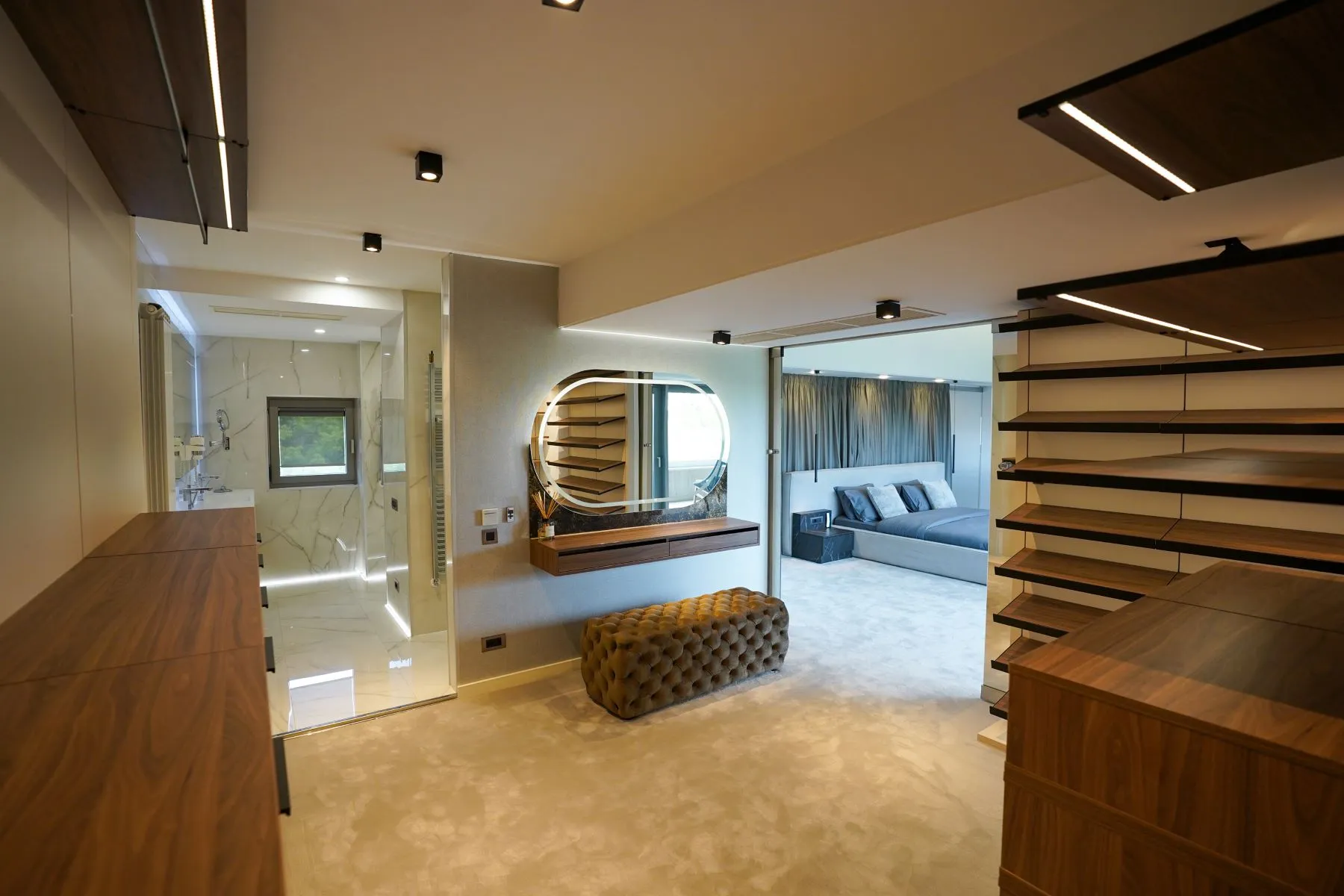 Master dressing suite with illuminated vanity and open wardrobe storage